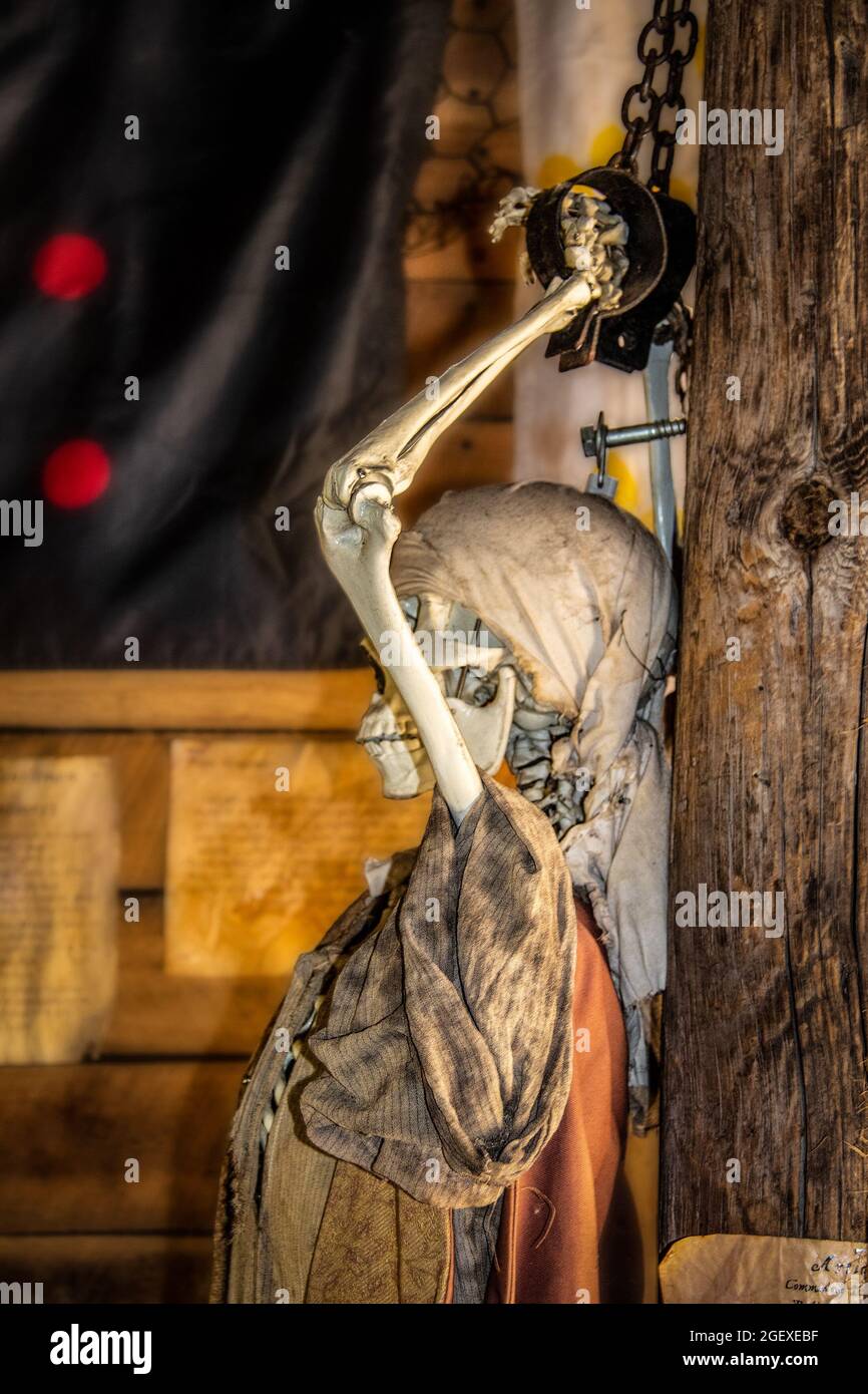 Skeleton pirate with hands chained to pole on ship Halloween decoration - side view Stock Photo