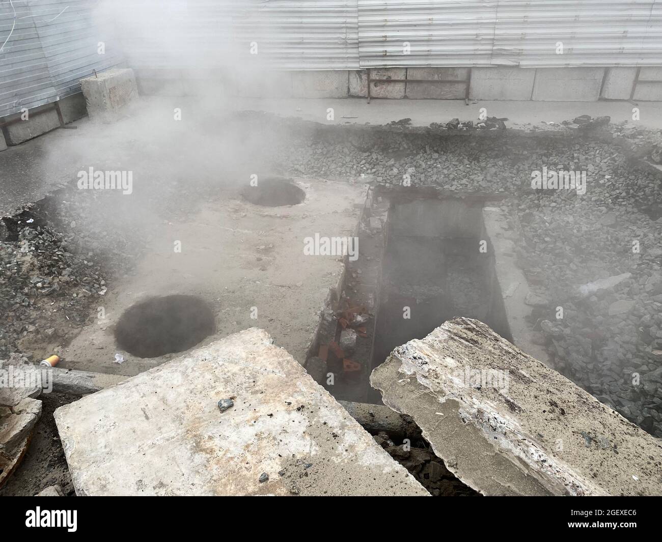 Repair of the heating main. The underground pipe through which steam flows is damaged Stock Photo