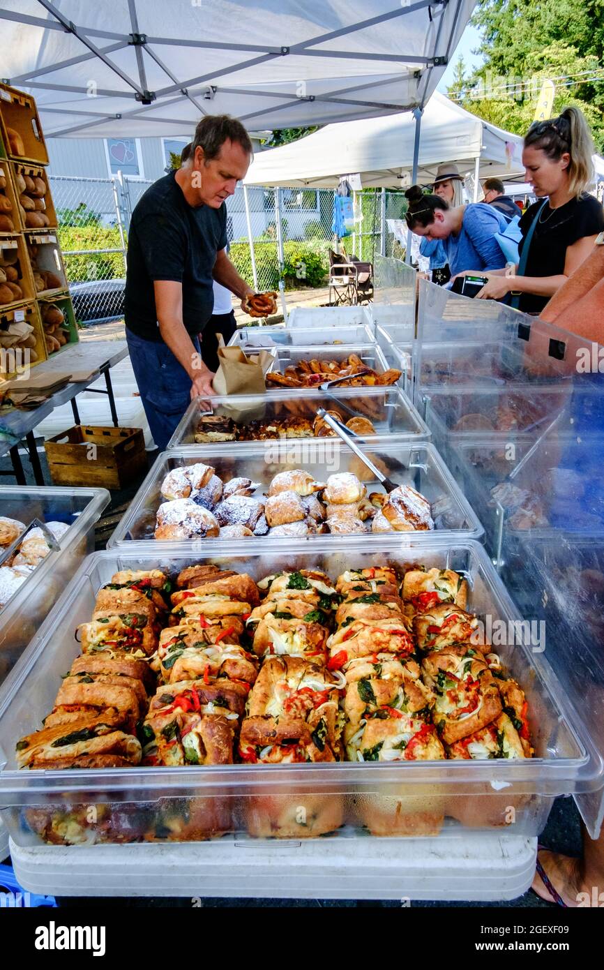 Customers purchasing baked goods from Bodhi's Artisan Bakery at the Qualicum Beach, British Columbia, Canada farmer's market Stock Photo