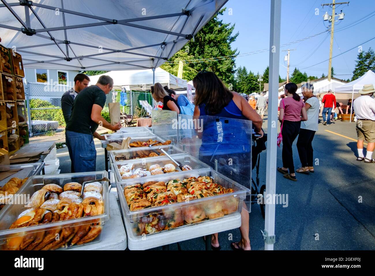Customers purchasing baked goods from Bodhi's Artisan Bakery at the Qualicum Beach, British Columbia, Canada farmer's market Stock Photo