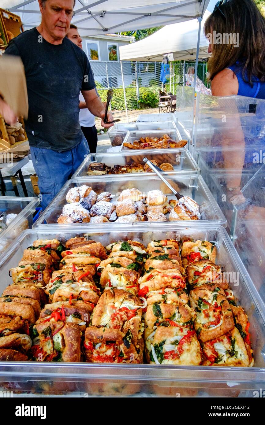 Customers purchasing baked goods from Bodhi's Artisan Bakery at the Qualicum Beach, British Columbia, Canada farmer's market Stock Photo