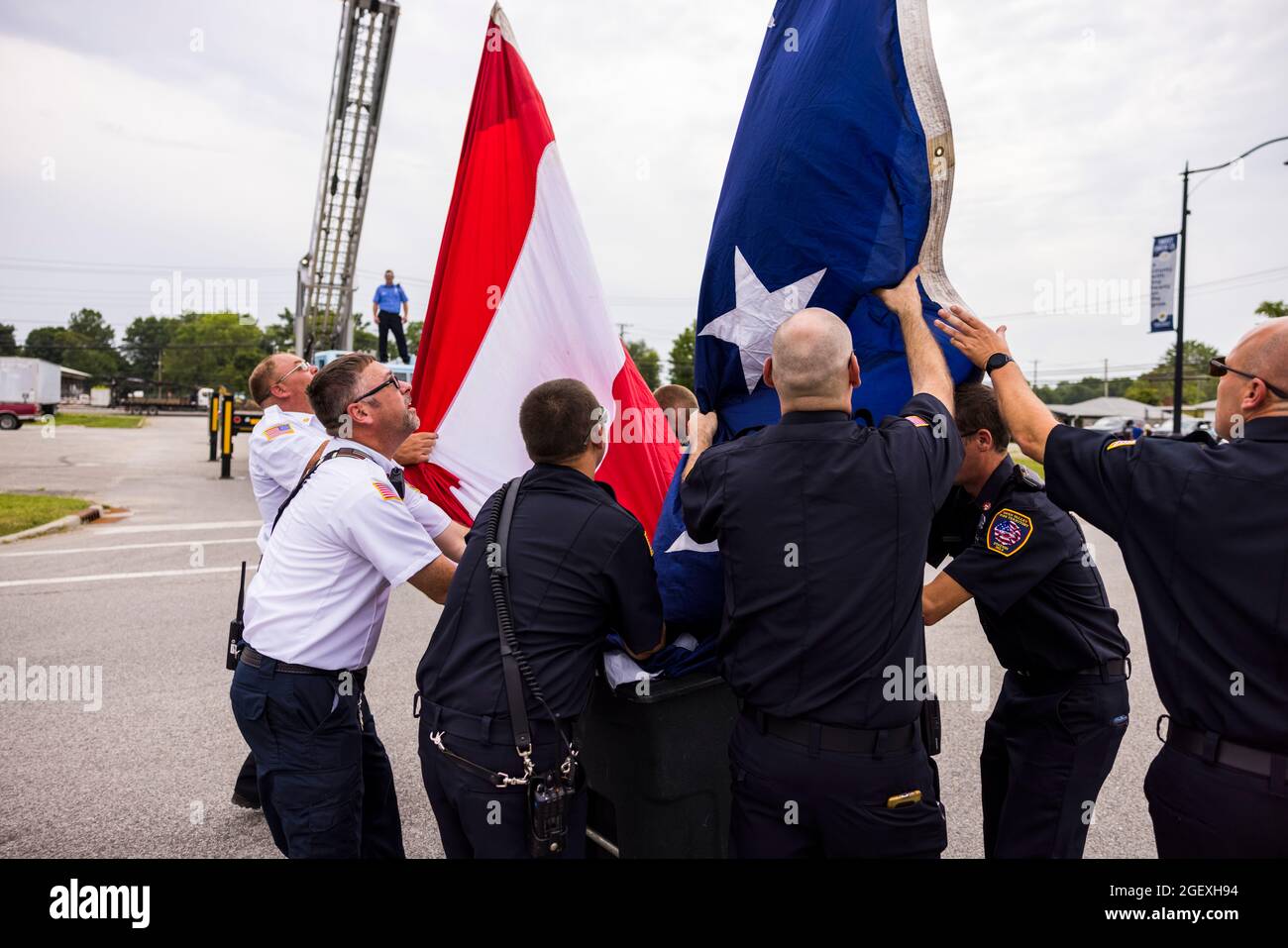 SPENCER, INDIANA - AUGEST 18: Firefighters lower an American flag after ...