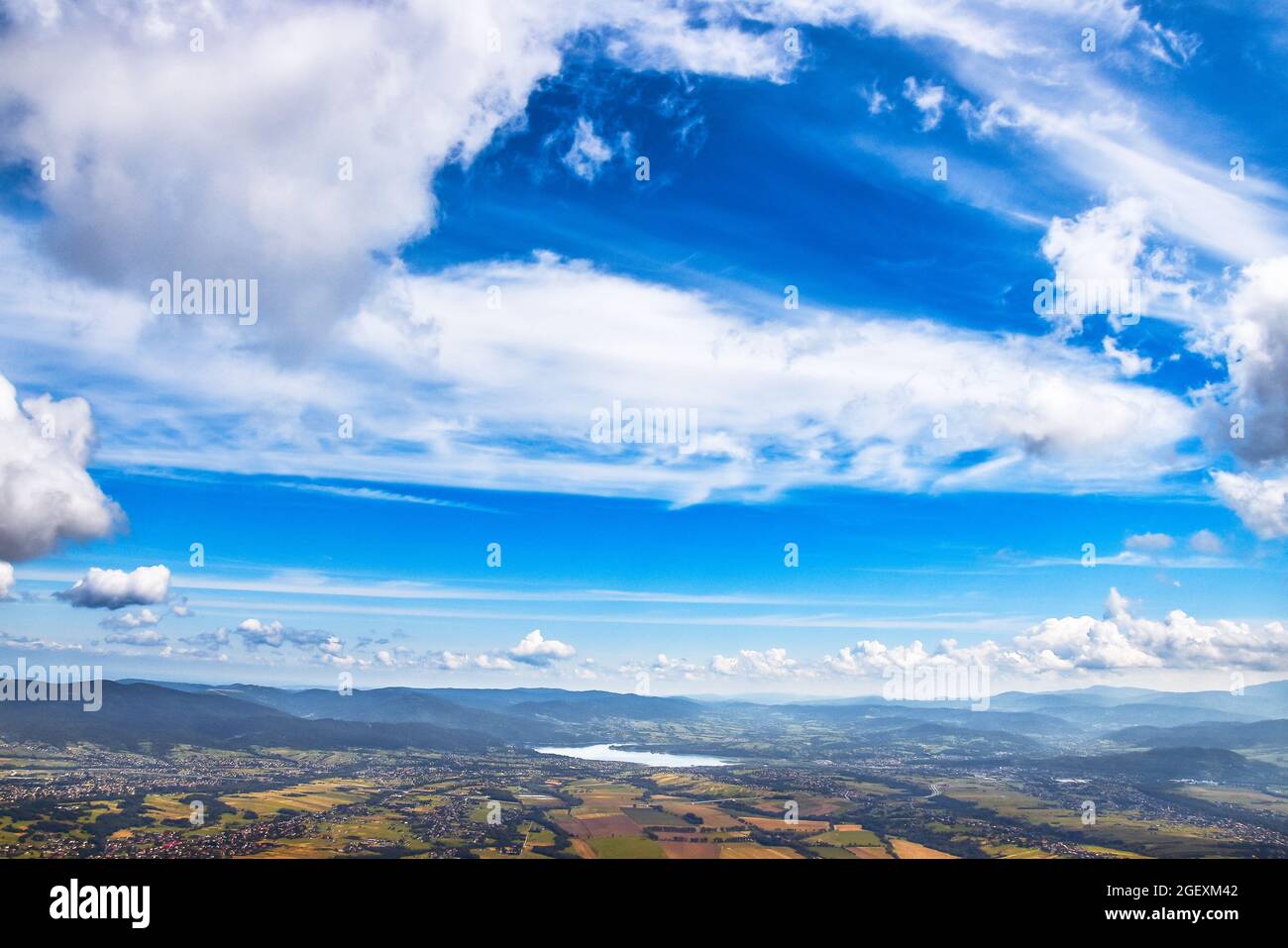 Aerial view on Żywieckie Lake and panoramic view on Beskidy Mountains seen from the way to Skrzyczne Mountain. Beautiful mountain landscape on a sunny Stock Photo