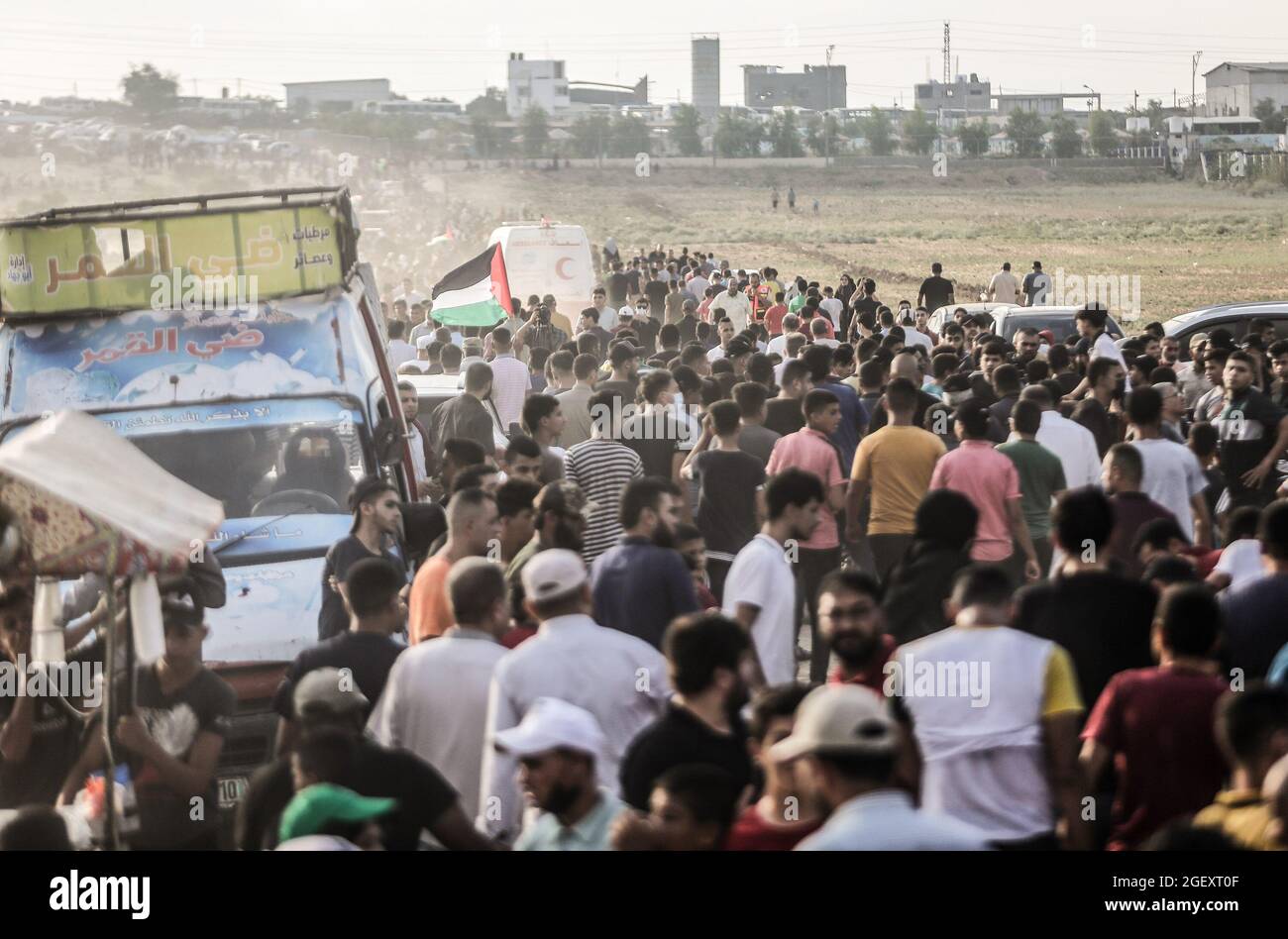 Palestinian Protesters Hurry Away As Tear Gas Canisters Shot By Israeli Security Forces From Across The Gaza Border Fall During The Demonstration By The Border Fence With Israel East Of Gaza City
