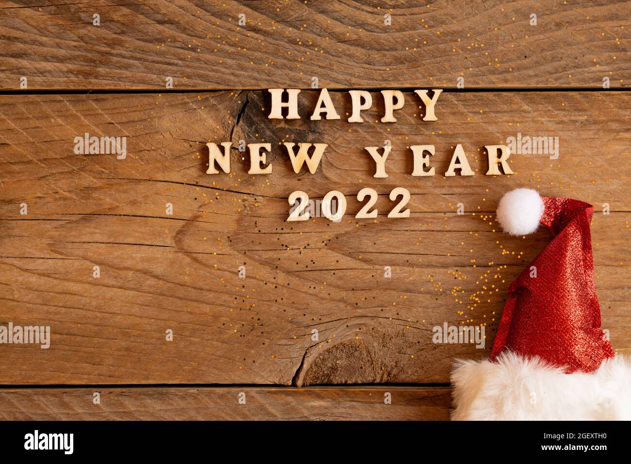 2022 Christmas Cards Backgrounds Emoticons Steam Festive Greeting Card For 2022 New Year With Red Santa Hat And Woodent Text  On A Table. Copw Psace For Text Stock Photo - Alamy