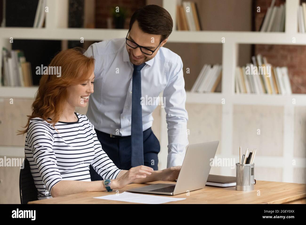 Friendly colleagues talk during workday in modern office Stock Photo