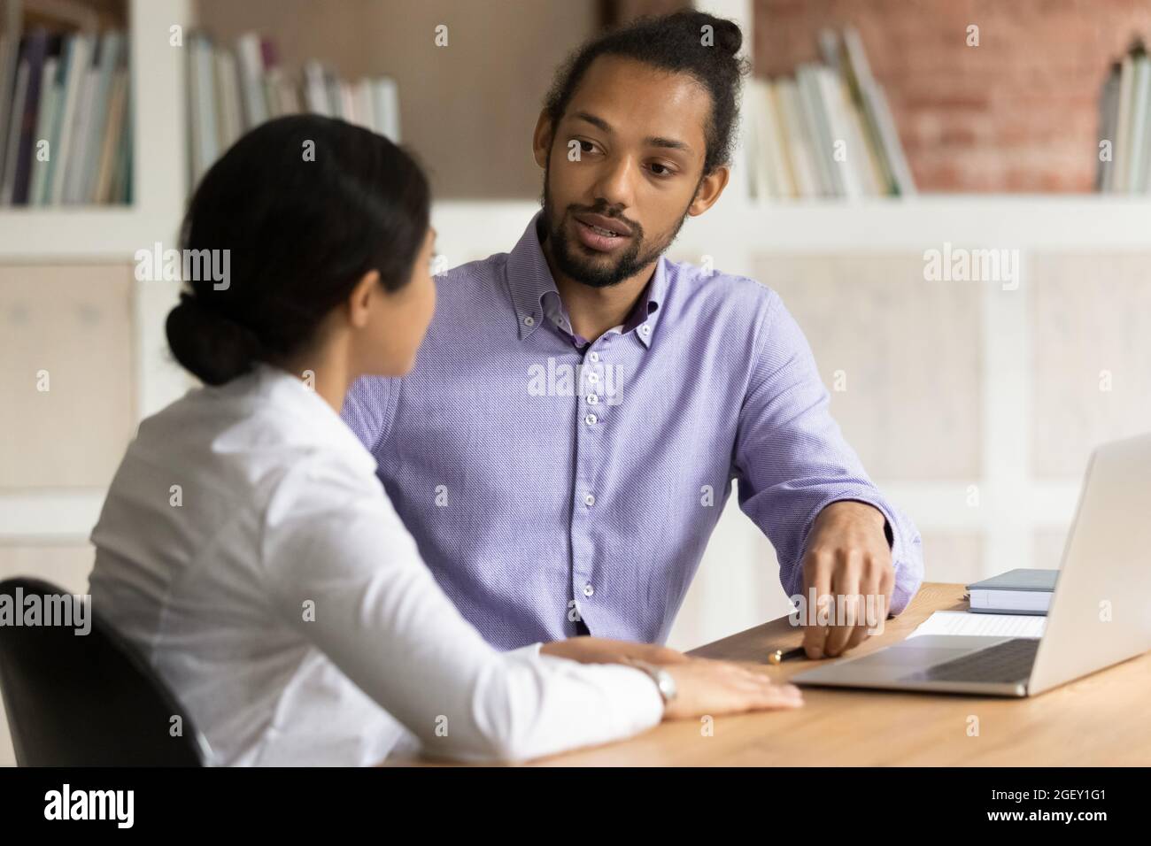 Multiracial workmates working on project at workplace with computer Stock Photo
