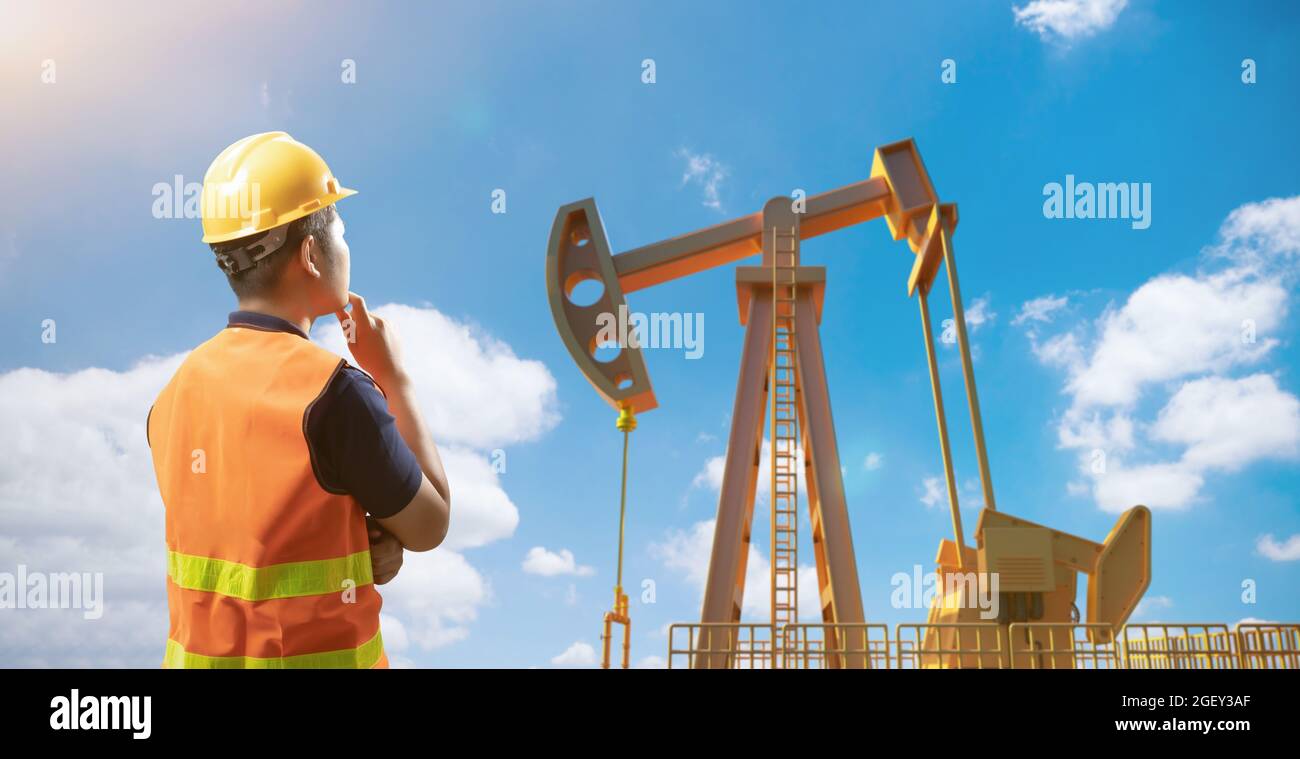 Oil rig engineer or technician wear safety helmet and reflective vest
