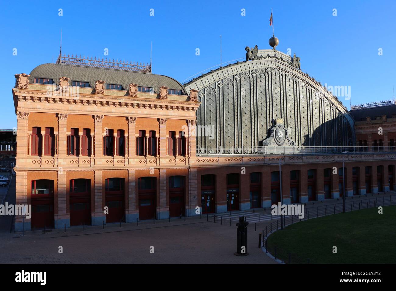 Facade of the Madrid Atocha railway station by architect Alberto de Palacio Elissagne Madrid Spain in low afternoon sun Stock Photo