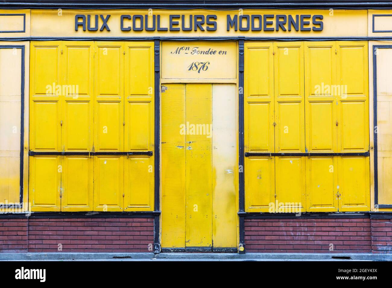 Yellow front of a closed store on a street in Paris Stock Photo