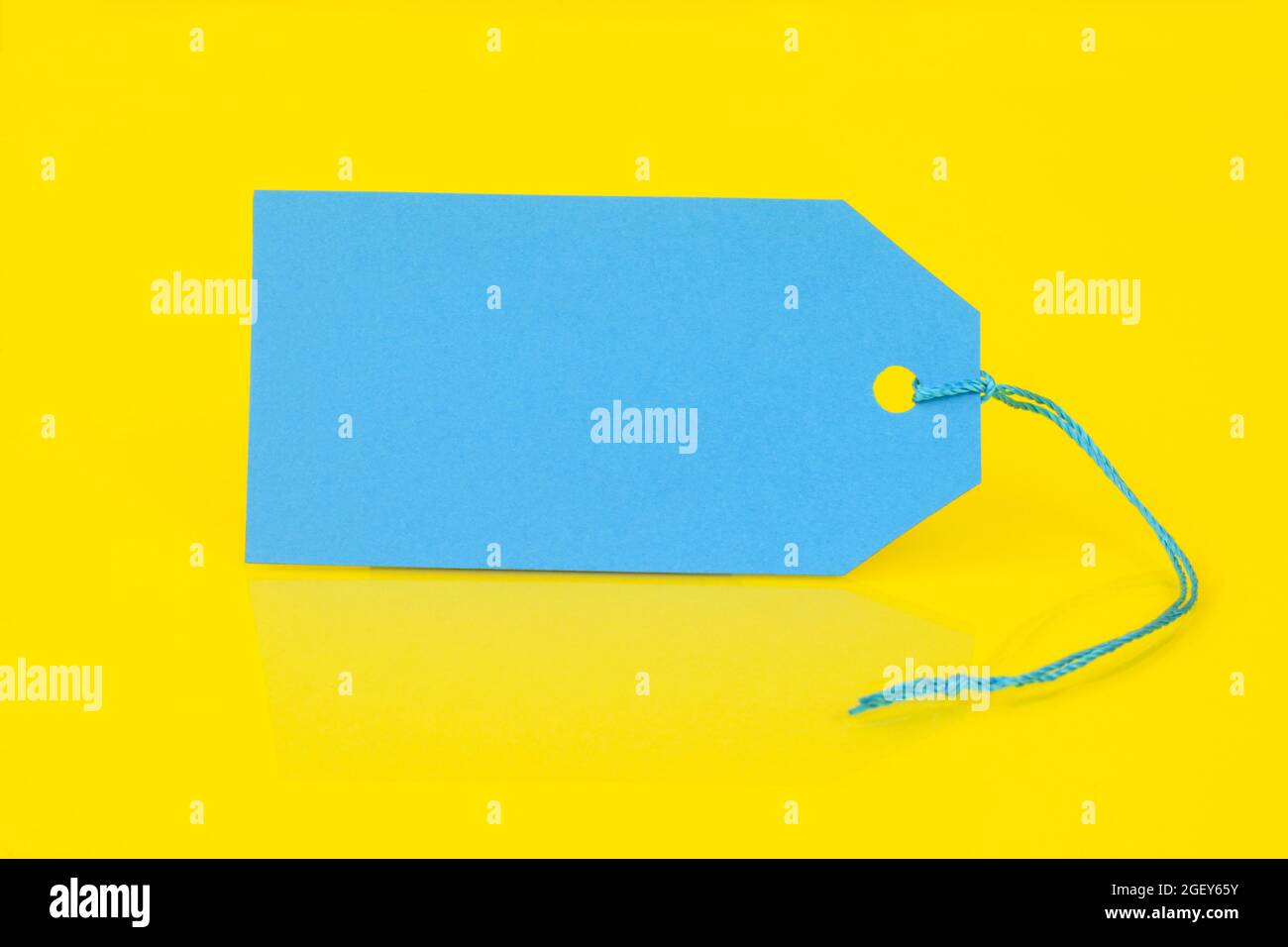 Isolated blank blue price tag on yellow background Stock Photo Alamy