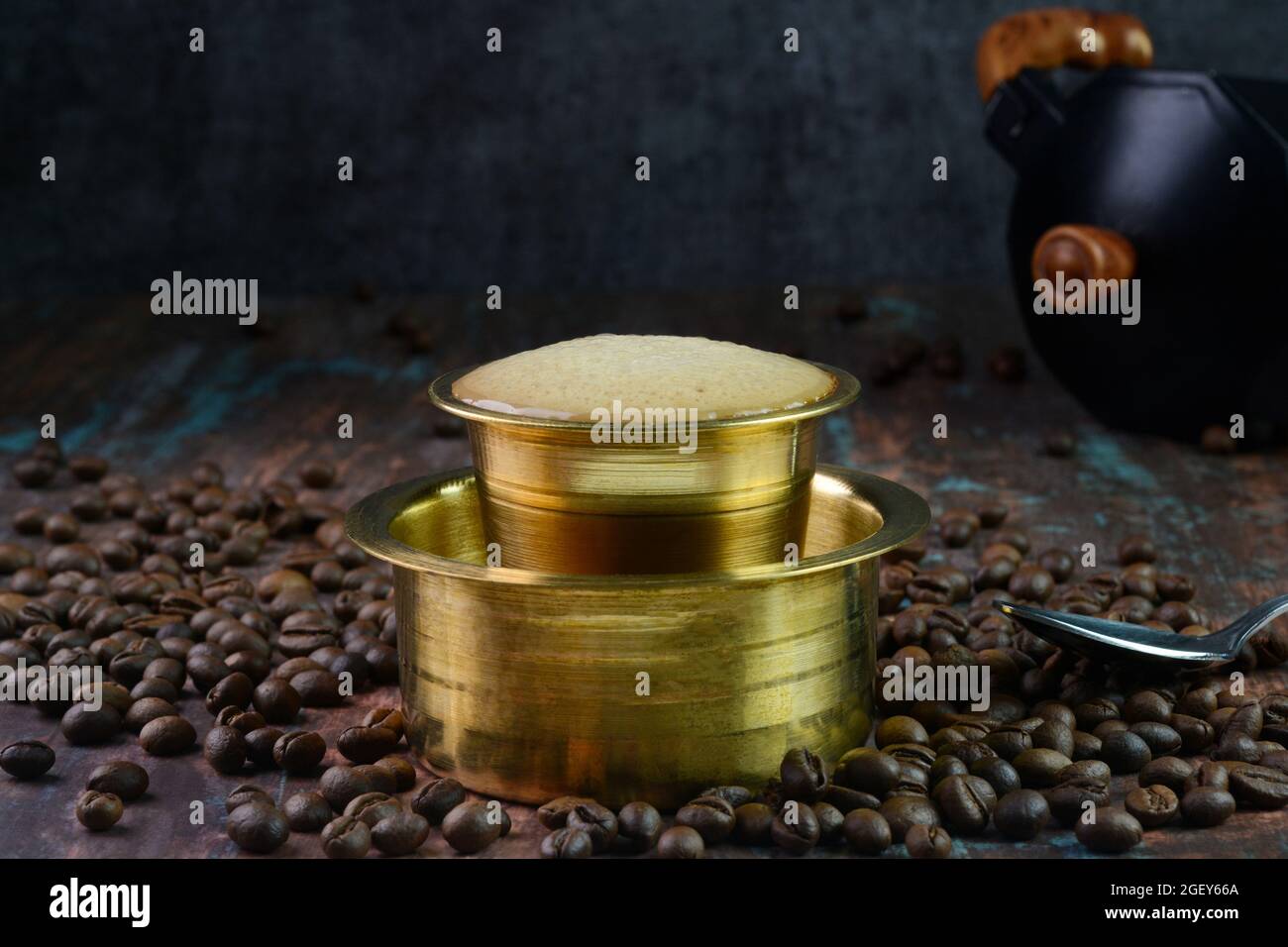 Indian filter coffee served in a brass cup Stock Photo
