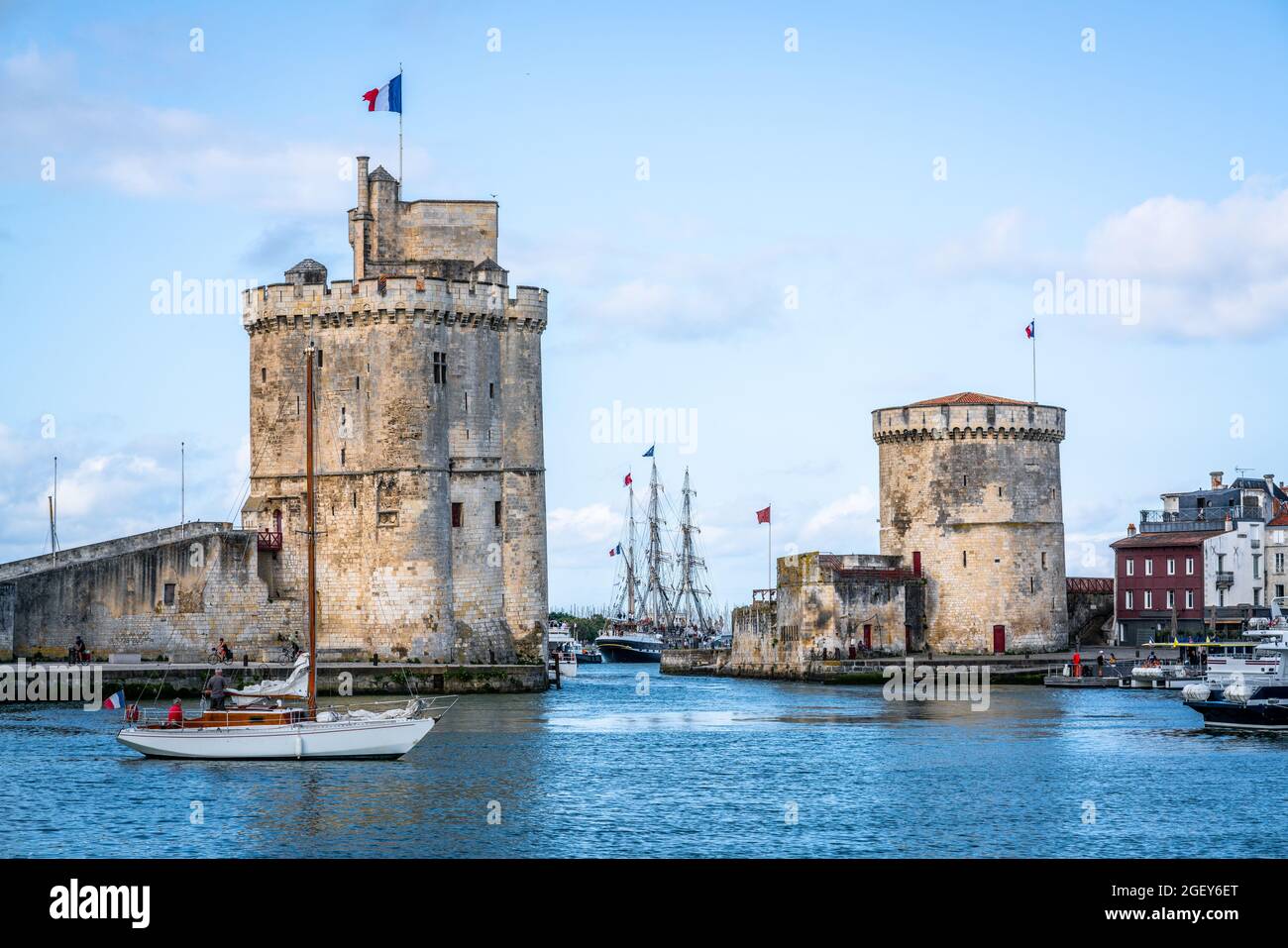 The Chain and Saint Nicolas towers of La Rochelle during summer with blue sky marking the entryway of the old port of La Rochelle France Stock Photo