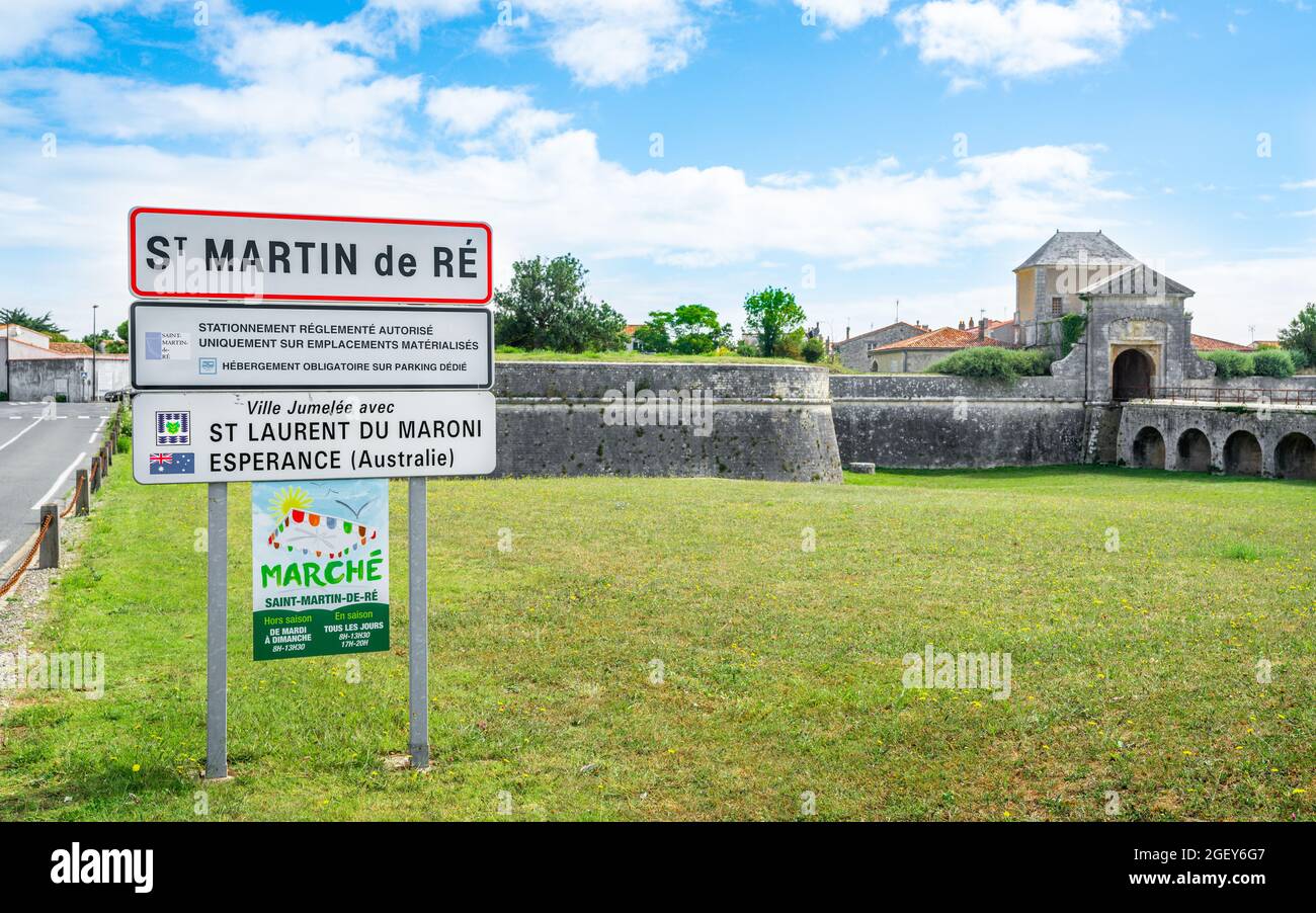 30 July 2021 , Saint-Martin-de-Ré France : Saint-Martin-de-Ré town sign and view of the city old fortification with Campani door of Vauban citadel in Stock Photo