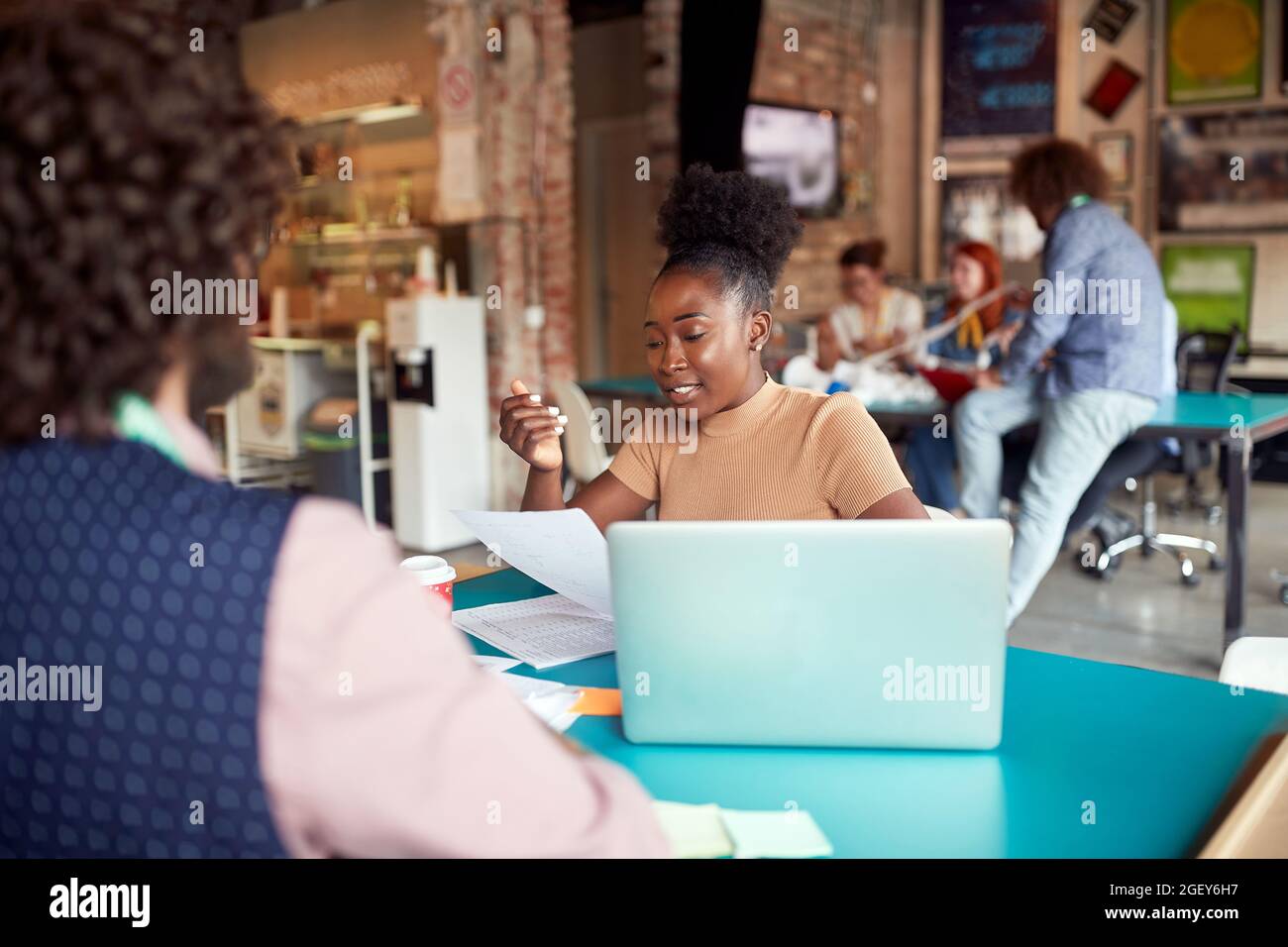 young afro american female employee consulting with her boss. modern creative open space office concept. Stock Photo