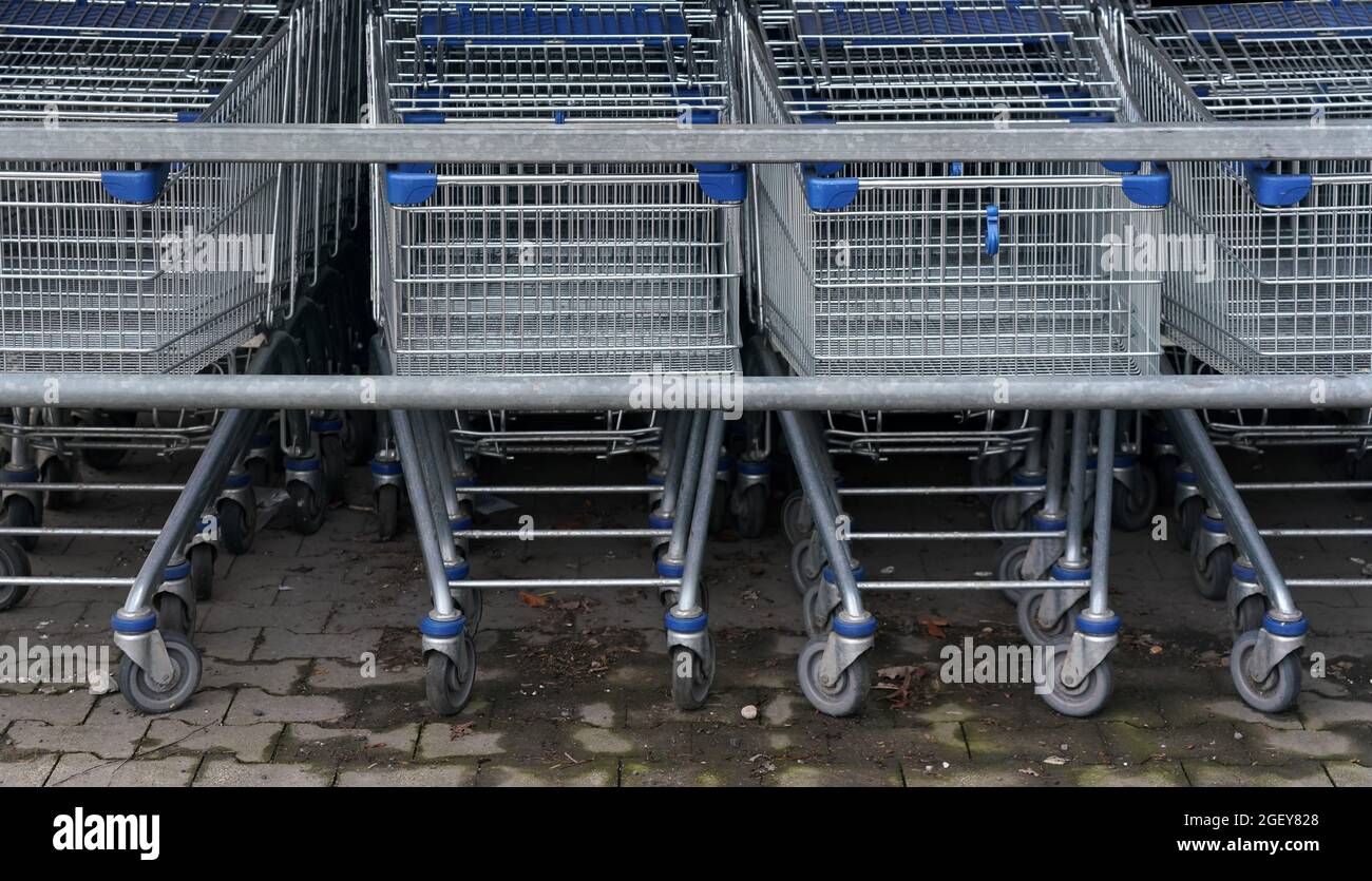 Closeup of metal shopping carts stacked in front of shop mall. Stock Photo