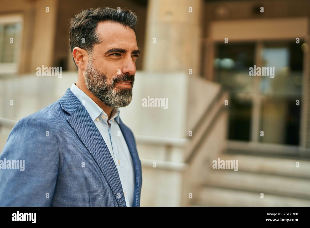 Middle age businessman smiling happy standing at the city Stock Photo ...