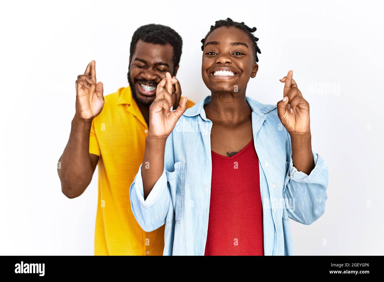 Young african american couple wearing casual clothes gesturing finger ...