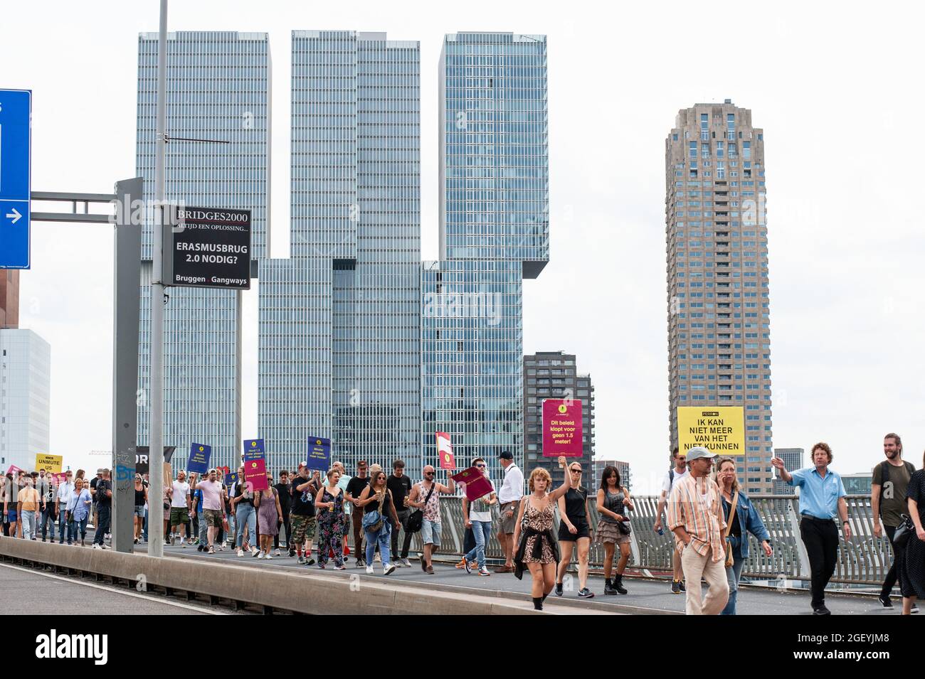 Rotterdam, Netherlands. 21st Aug, 2021. Erasmus Bridge, Rotterdam, Netherlands. Saturday 21st August, 2021. Tens of thousands or protesters took to the streets in six major cities' of the Netherlands today. The demonstrators showed their disapproval regarding government measures or restrictions relating to the entertainment sector and, the Covid-19 pandemic; restrictions they consider to be of double standards. Demonstrations are demanding the events sector should open its doors to full capacity as of Credit: Charles M Vella/Alamy Live News Stock Photo