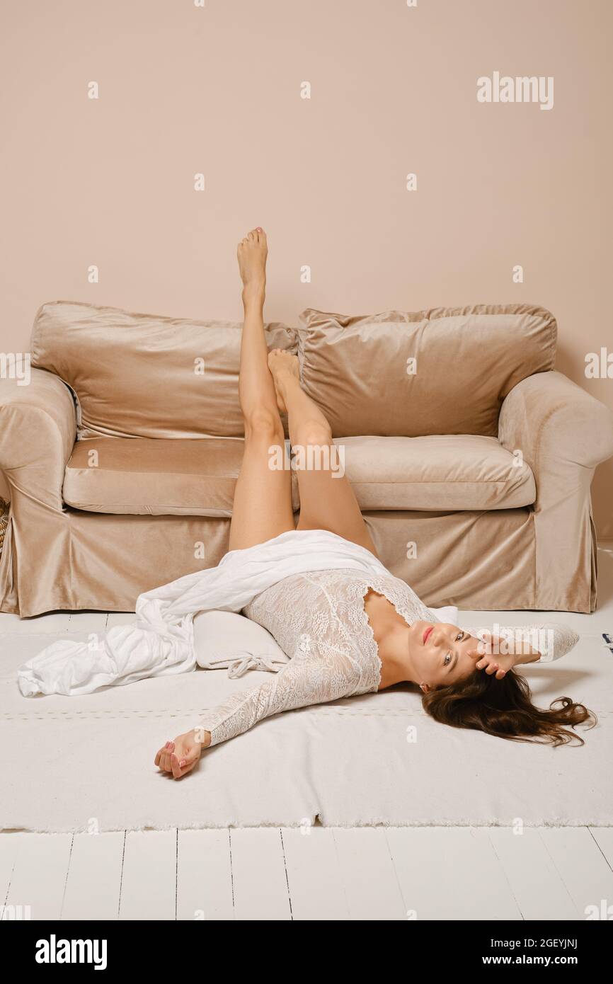 A Young Woman Lying on the Floor in the Studio Showing Her Big Long Legs  and Bottom, on a White Background. Copy Space Stock Photo - Image of legs,  fitness: 181216346