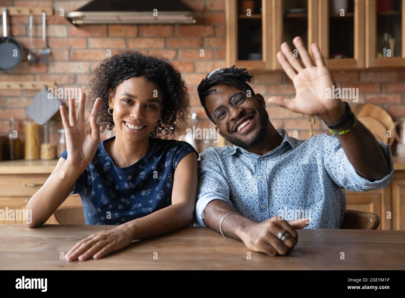 Happy millennial mixed race husband and wife making video call Stock