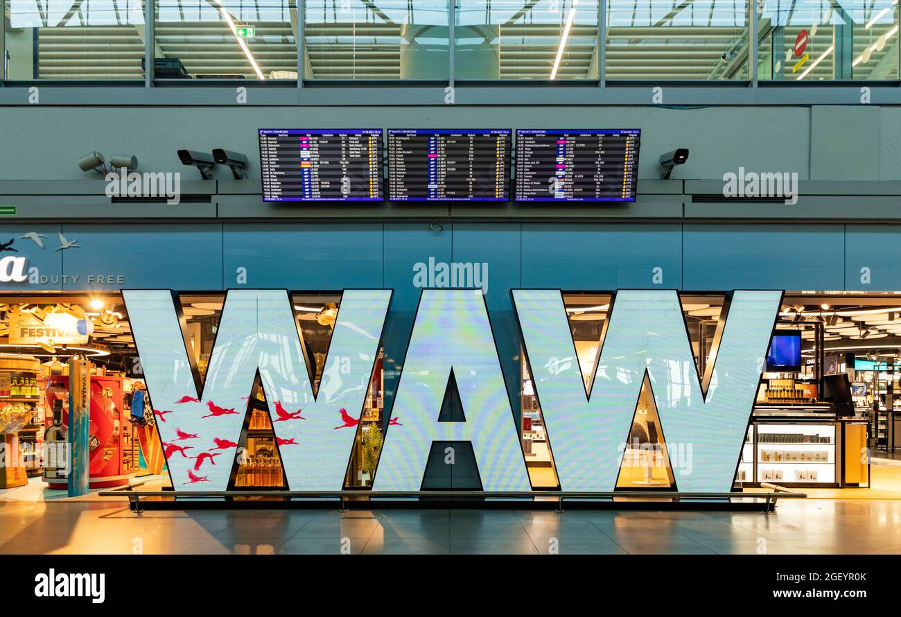 A picture of the WAW sign inside the Warsaw Chopin Airport with an ...
