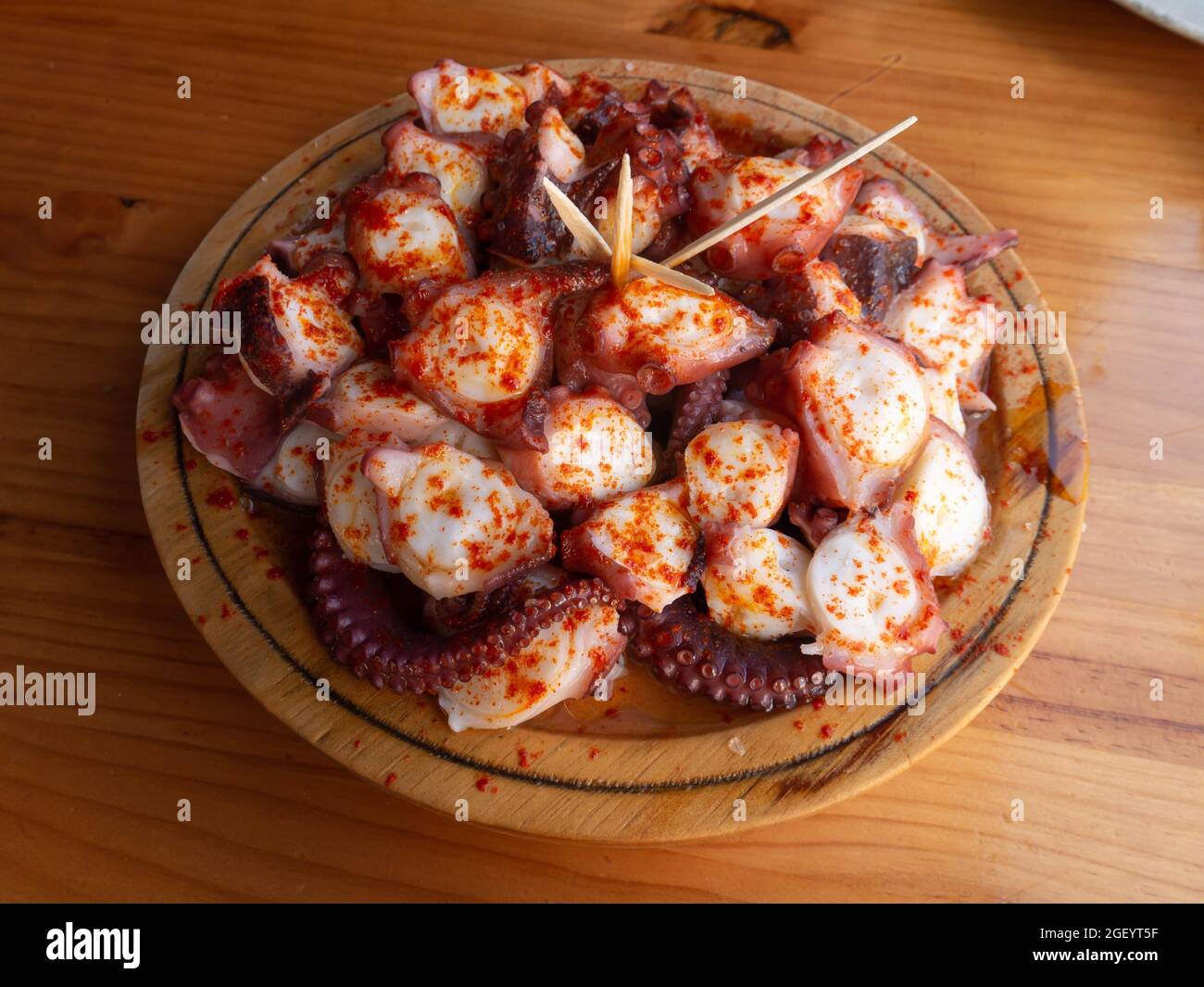 Pulpo a la gallega in Spanish meaning Galician-style octopus or polbo a feira meaning fair-style octopus in gallego. Stock Photo