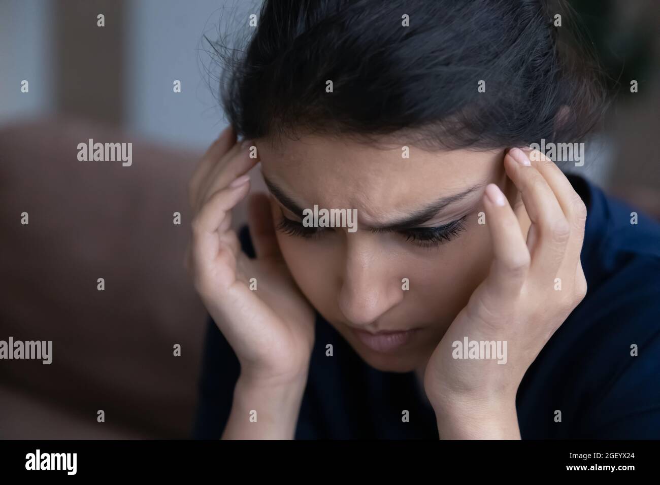 Sad Indian woman feel depressed thinking at home Stock Photo