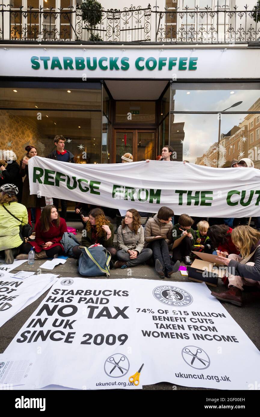 Protests outside the Starbucks Coffee shop, 6A Vigo Street, London, UK. The protest was to highlight the small amount of corporation tax that Starbucks pays in the Britain when compared to their turnover. Starbucks Coffee shop, Conduit Street, London, UK.  8 Dec 2012 Stock Photo