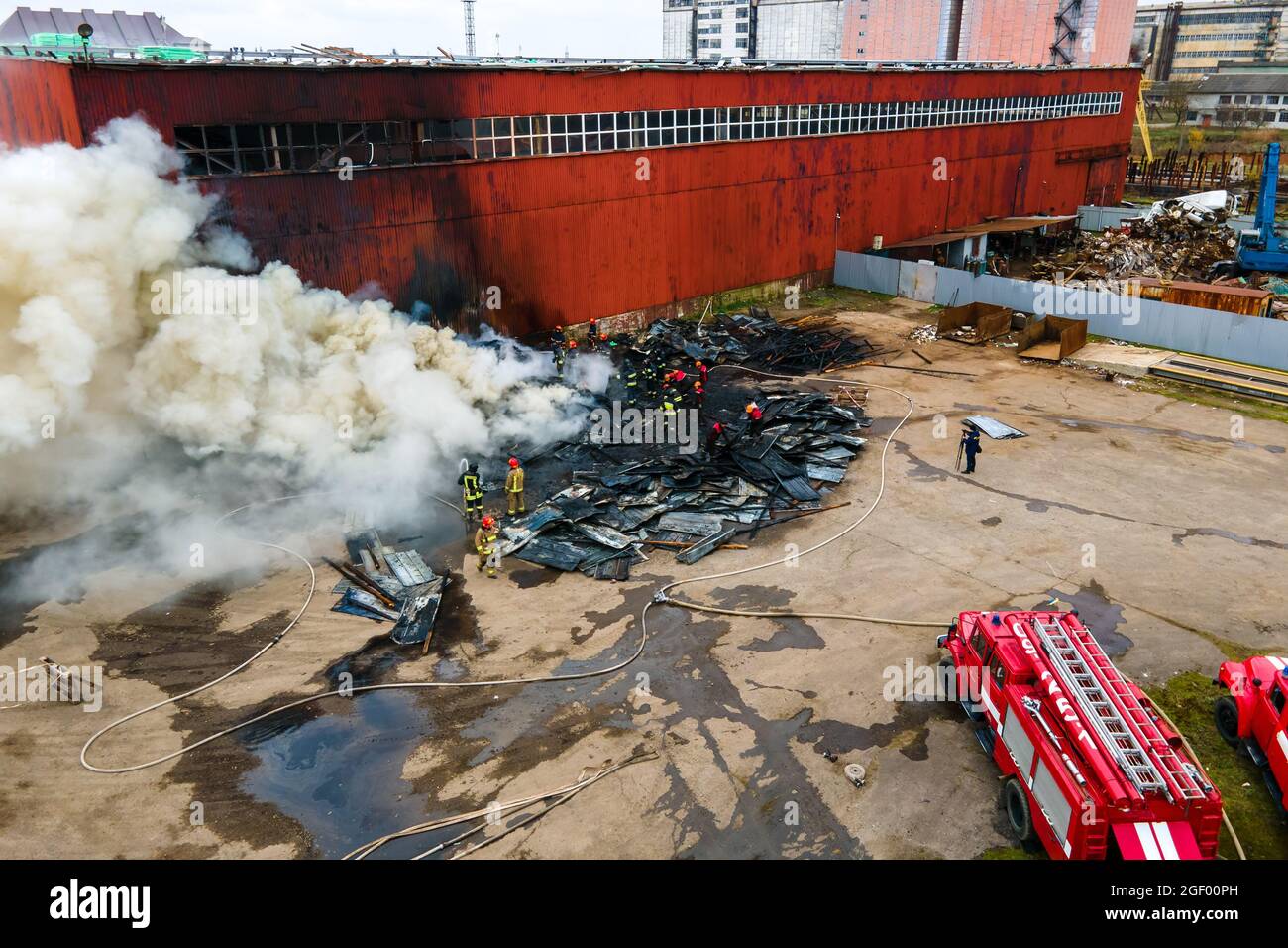 Aerial view of firefighters extinguishing fire in industrial area Stock ...