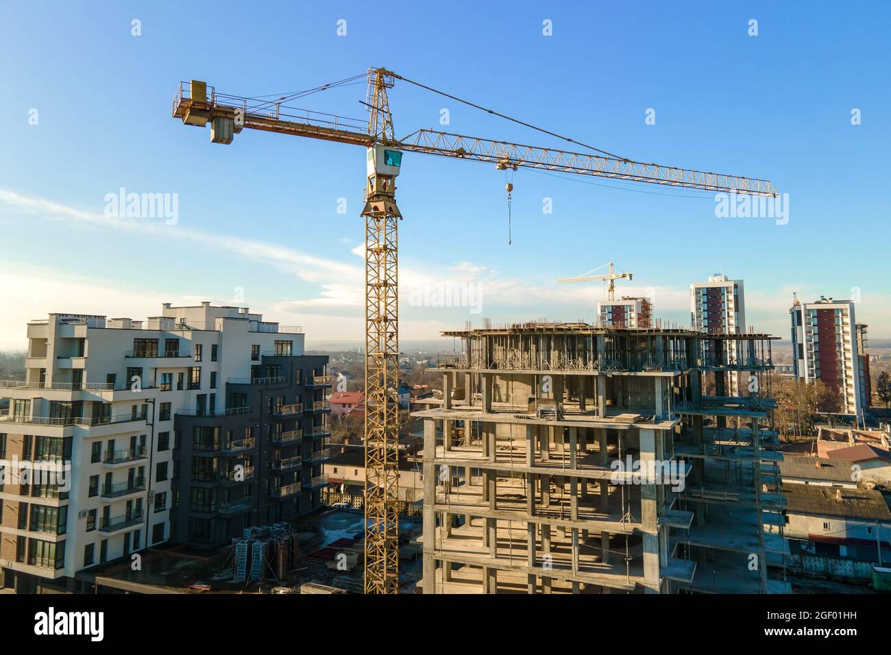 Aerial view of high tower crane and residential apartment buildings ...