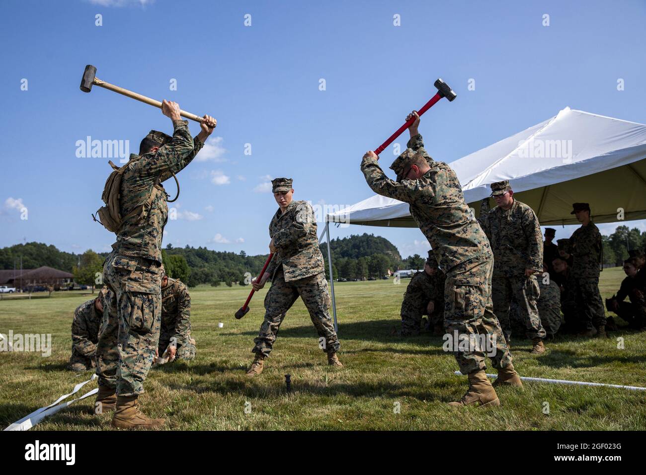 U.S. Marines from Marine Wing Support Squadron 471 hammer a tent spike to raise reception tents for the arrival of Afghans at Volk Field Air National Guard Base, Wisconsin, on August 19, 2021. The Department of Defense, in support of the Department of State, is providing transportation and temporary housing in support of Operation Allies Refuge. This initiative follows through on America's commitment to Afghan citizens who have helped the United States, and provides them essential support at secure locations outside Afghanistan. Photo by 1st Sgt. Michel Sauret/U.S. Army/UPI Stock Photo
