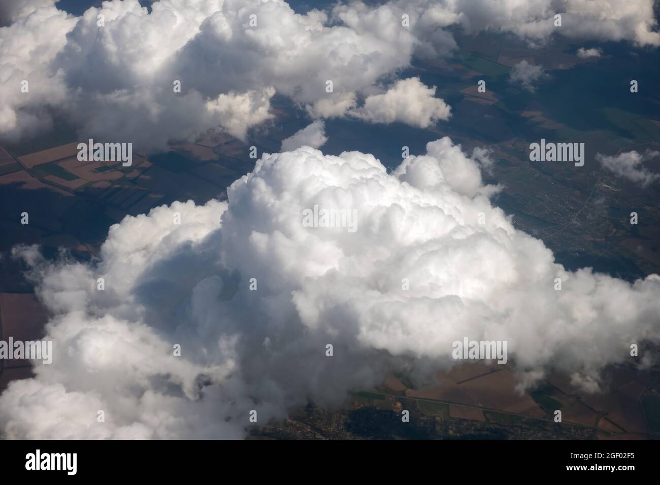 Aerial view from airplane window of white puffy clouds on bright sunny ...