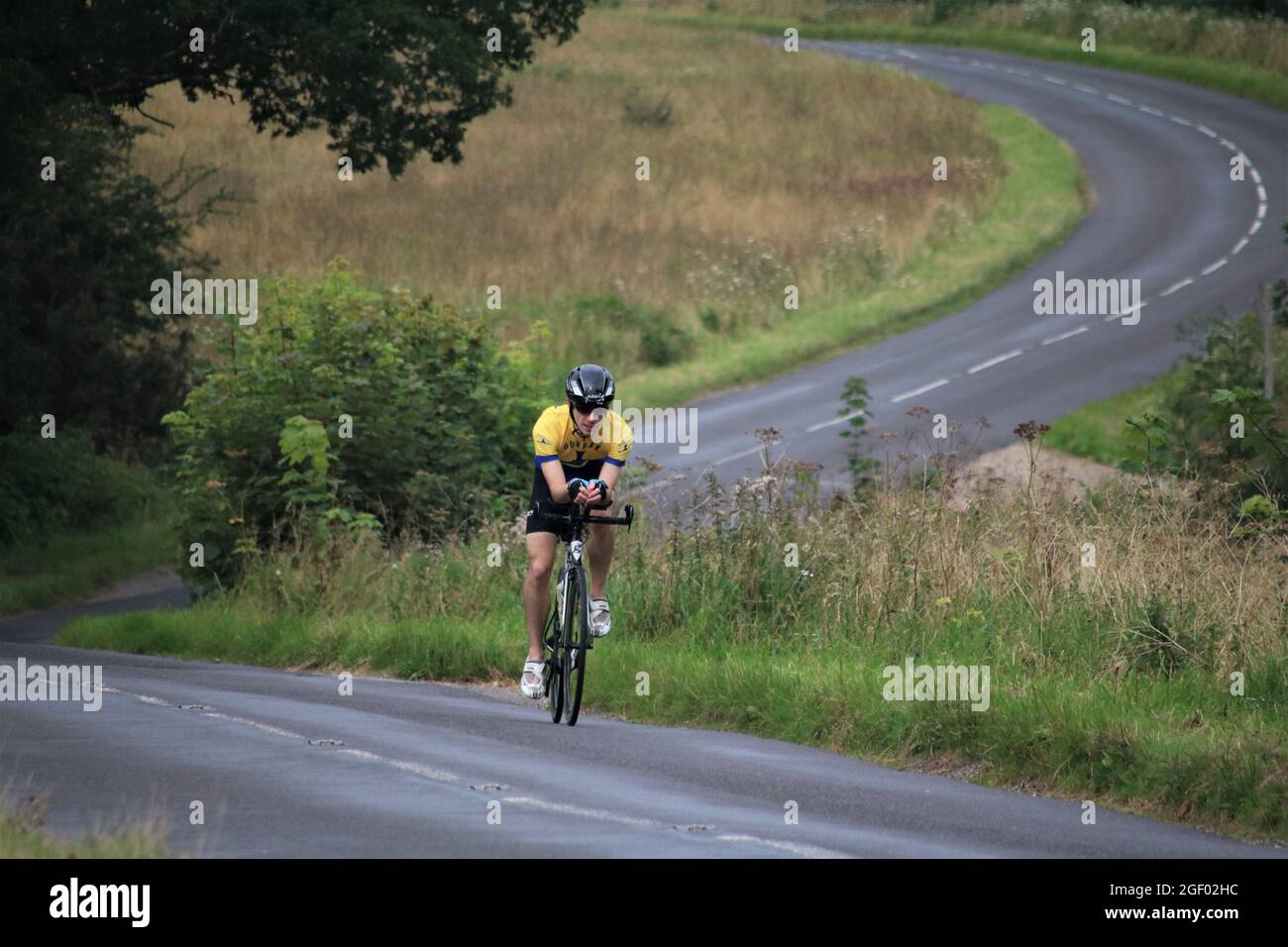 single male cyclist on deserted road in the surrey hills Stock Photo ...