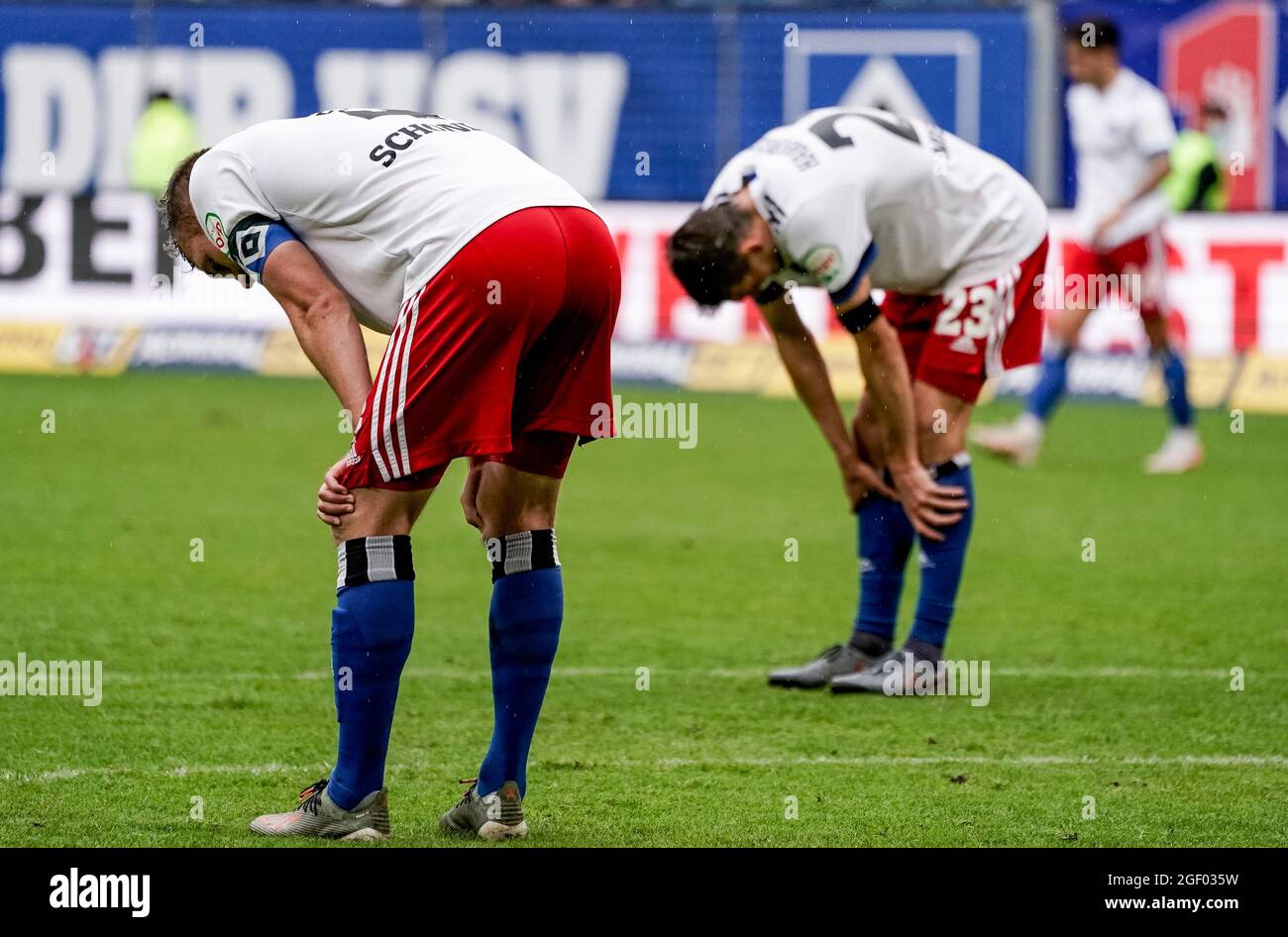 Hamburg, Germany. 22nd Aug, 2021. Football: 2nd Bundesliga, Hamburger SV - Darmstadt 98, Matchday 4 at Volksparkstadion. Hamburg's Sebastian Schonlau (l) and Hamburg's Jonas Meffert stand on the pitch after the match. Credit: Axel Heimken/dpa - IMPORTANT NOTE: In accordance with the regulations of the DFL Deutsche Fußball Liga and/or the DFB Deutscher Fußball-Bund, it is prohibited to use or have used photographs taken in the stadium and/or of the match in the form of sequence pictures and/or video-like photo series./dpa/Alamy Live News Stock Photo