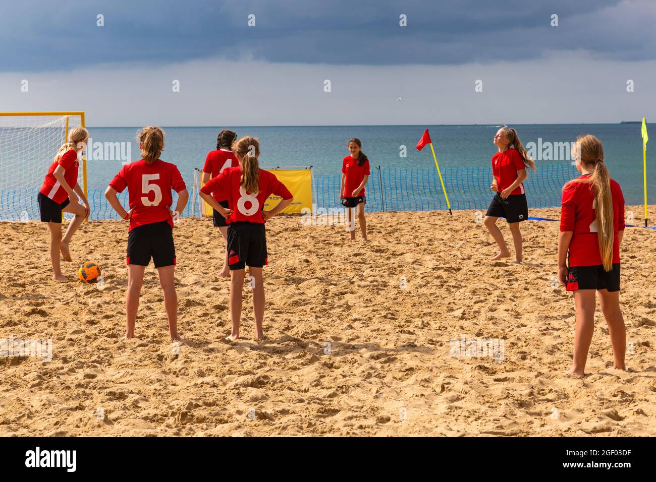 Bournemouth, Dorset, UK. 22nd August 2021. Beach Fest, International beach soccer, the final day of the festival takes place on the beach at Bournemouth, with over 60 beach soccer teams competing with teams of boys, girls, men and women. As well as beach soccer, there is beach volleyball, foot volley and teqball showcase matches. Girls playing beach soccer. Credit: Carolyn Jenkins/Alamy Live News Stock Photo
