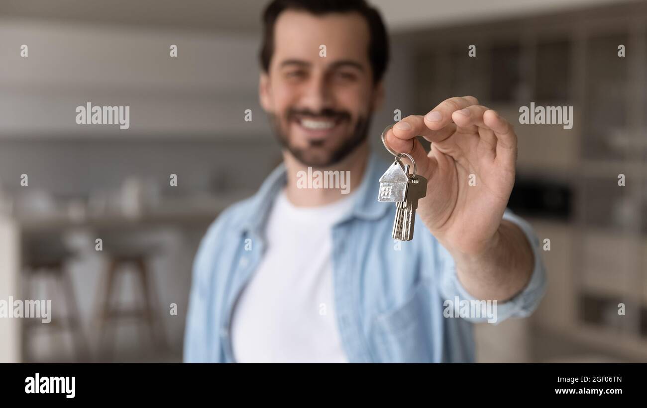 Happy successful male real estate agent offering buying house Stock