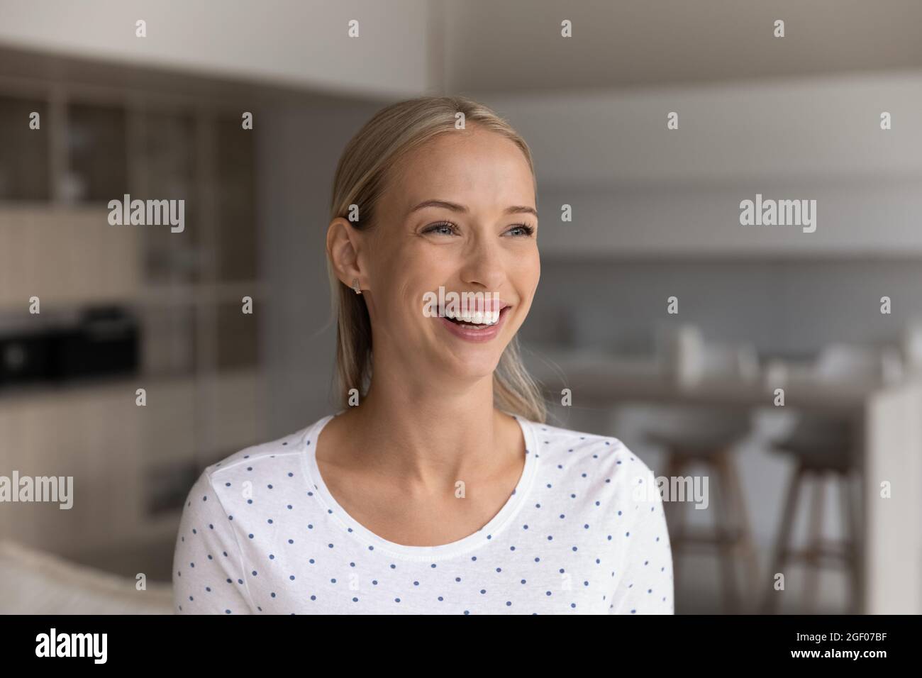 Happy beautiful 30s blonde woman home head shot portrait Stock Photo