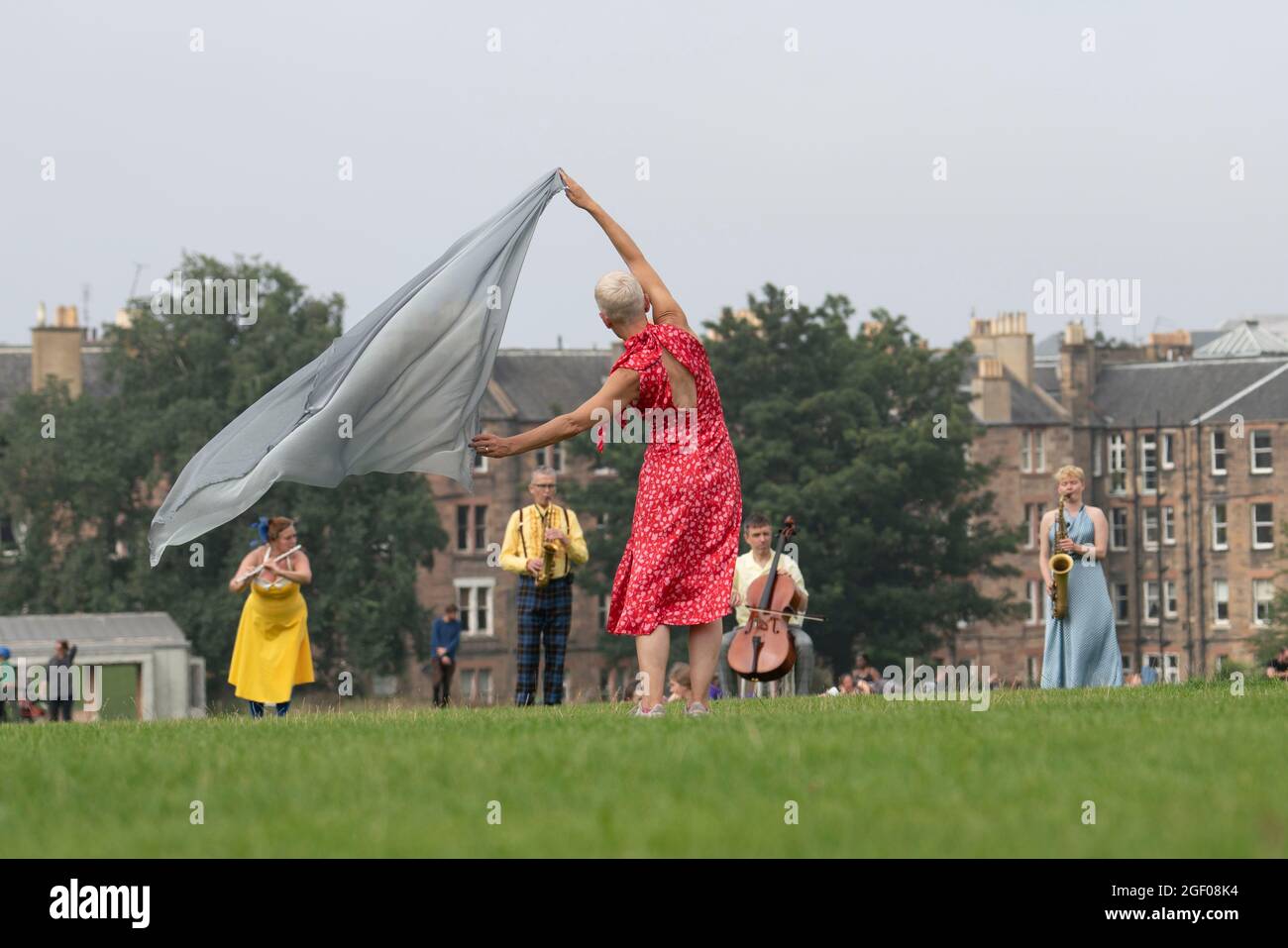 Edinburgh, Scotland, UK. 22nd August 2021. Outdoor dance performance held in Holyrood Park as part of the Edinburgh International Festival. Field -  Something for the Future Now is directed by Christine Devaney and features an ensemble of Edinburgh-based performers, Field is an immersive, uplifting work and performers respond to the surrounding landscape and each other by following a series of movement and live sound scores.that has Arthur’s Seat as its backdrop. Iain Masterton/Alamy Live News. Stock Photo