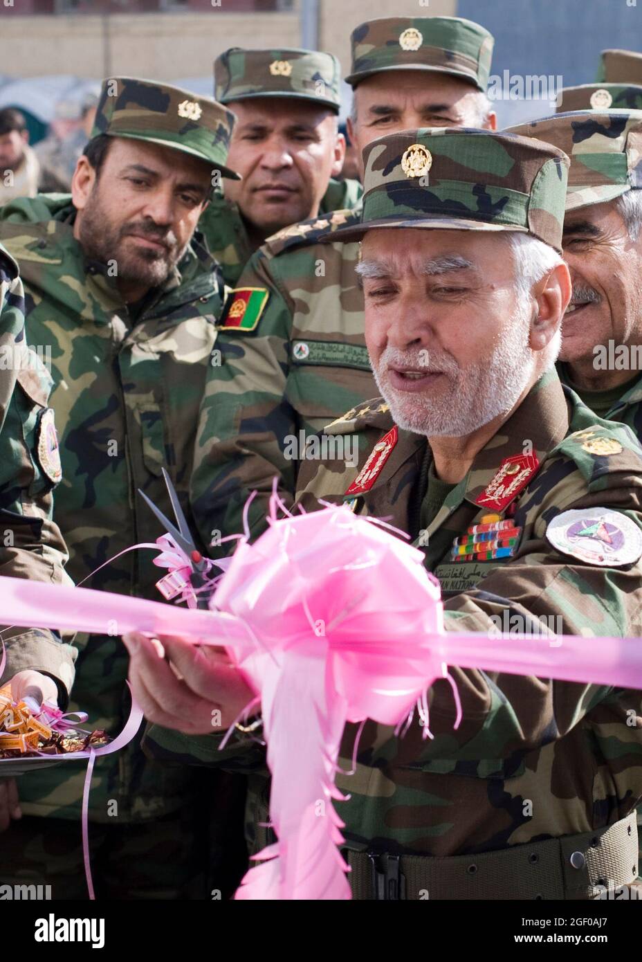 KABUL, Afghanistan (Feb. 9, 2011) - Maj. Gen. Shir Zazai, Commandant for the Afghan National Army National Military Academy of Afghanistan, prepares to cut a ribbon to officially open a new building at the academy Feb. 9, 2011 in Kabul, Afghanistan. The ribbon cutting celebrates the opening of a new building containing 32 classrooms and a library as well as increasing student capacity by more than 300. NATO Training Mission-Afghanistan advisers provide guidance to Afghan National Army instructors charged with conducting the bulk of training at the academy. (U.S. Navy photo by Petty Officer 2nd Stock Photo