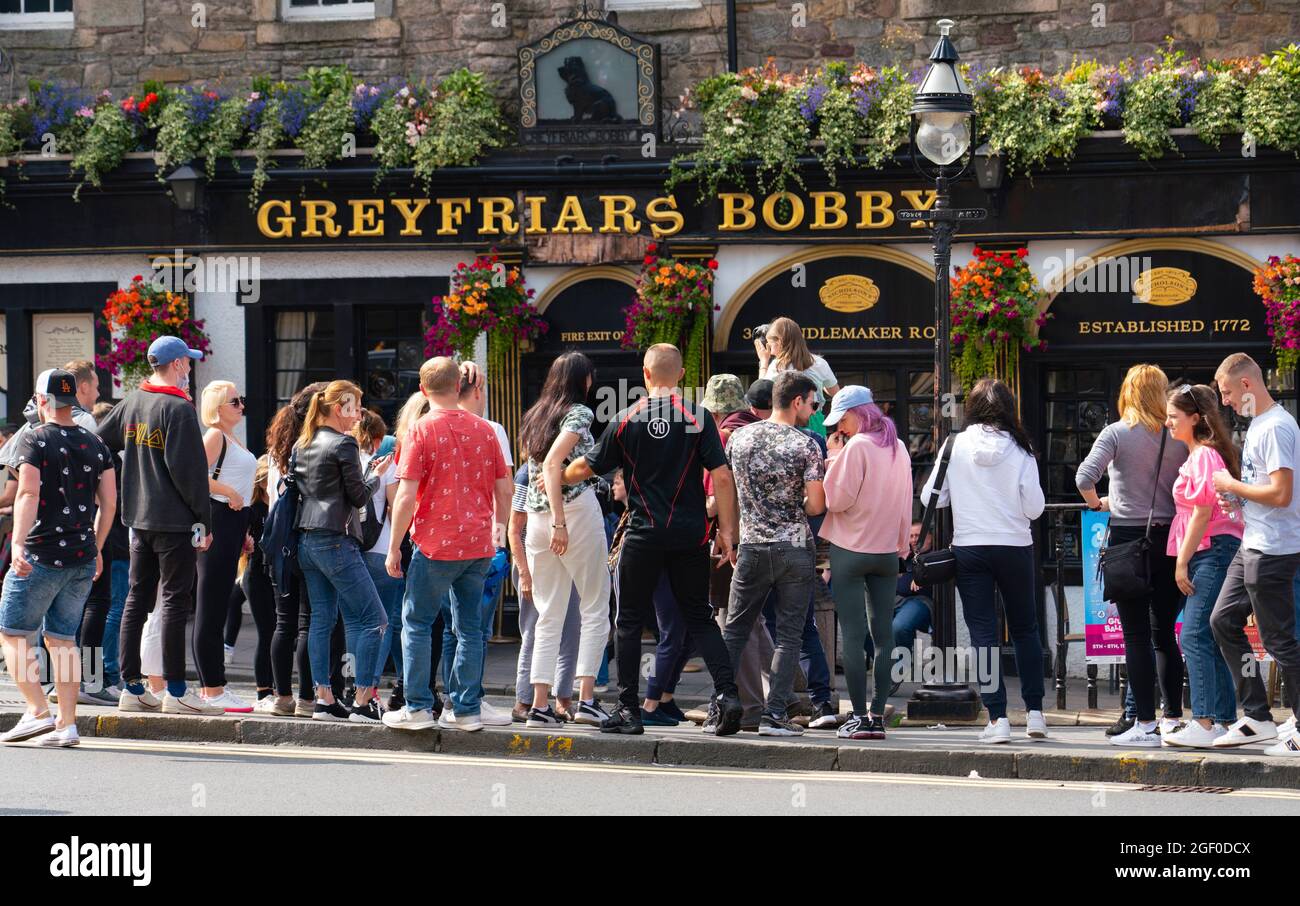 Edinburgh, Scotland, UK. 22nd August 2021. Good weather brought many visitors to Edinburgh during the festival and many came to pay respects to the Greyfriars Bobby statue on Candlemaker Row in the Old Town. . Iain Masterton/Alamy Live News. Stock Photo