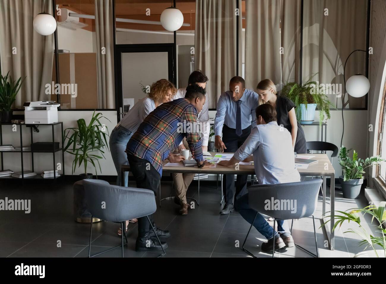 Multiethnic colleagues negotiate brainstorm at team meeting Stock Photo ...