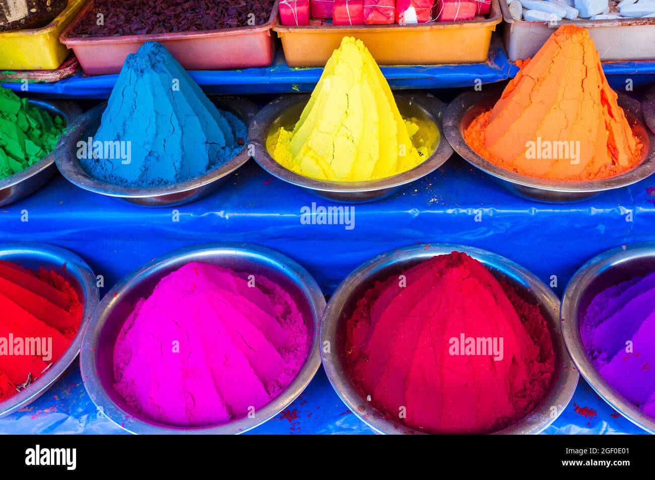 Mysore, Karnataka, India : Conical piles of kumkum coloured powder used for bindi dots for sale at Devaraja market. Stock Photo