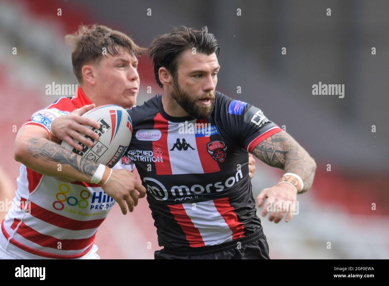 Keanan Brand (24) of Leigh Centurions attempts to tackle Andy Ackers (9) of Salford Red Devils Stock Photo