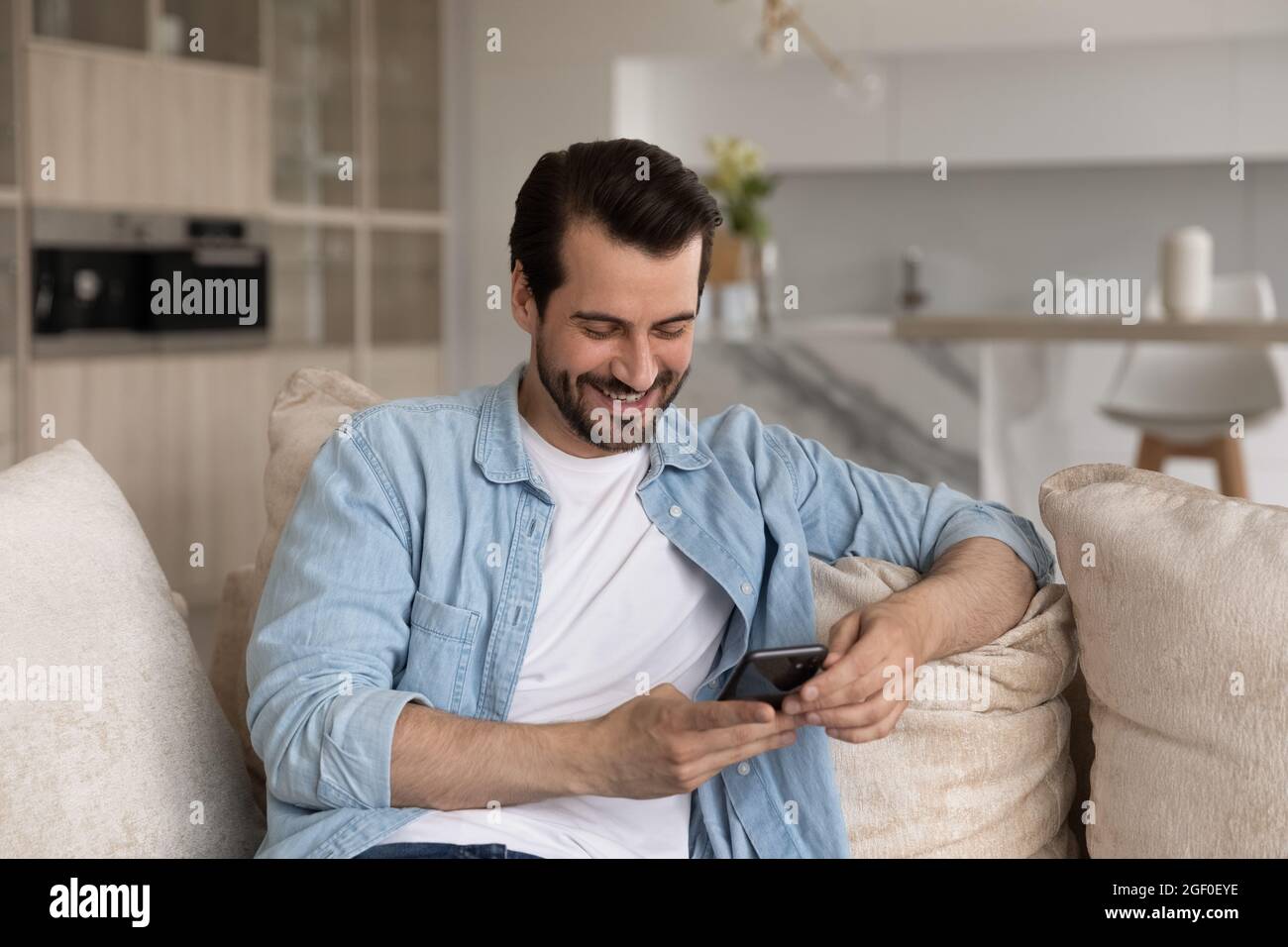 Happy cellphone user getting good news, reading text message Stock Photo
