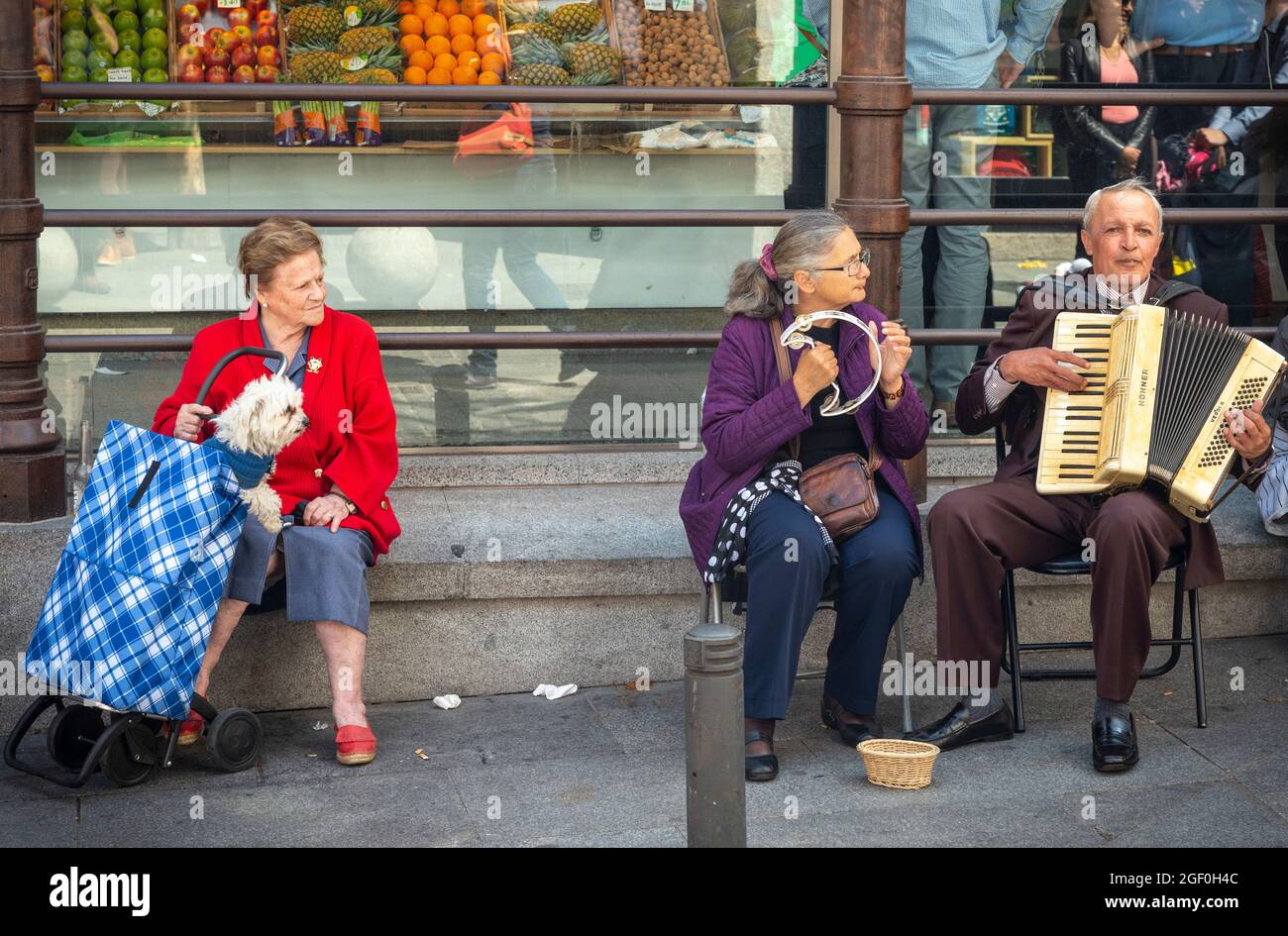 Street entertainers and their audience in  the Plaza de San Miguel,  Madrid, Spain. Stock Photo