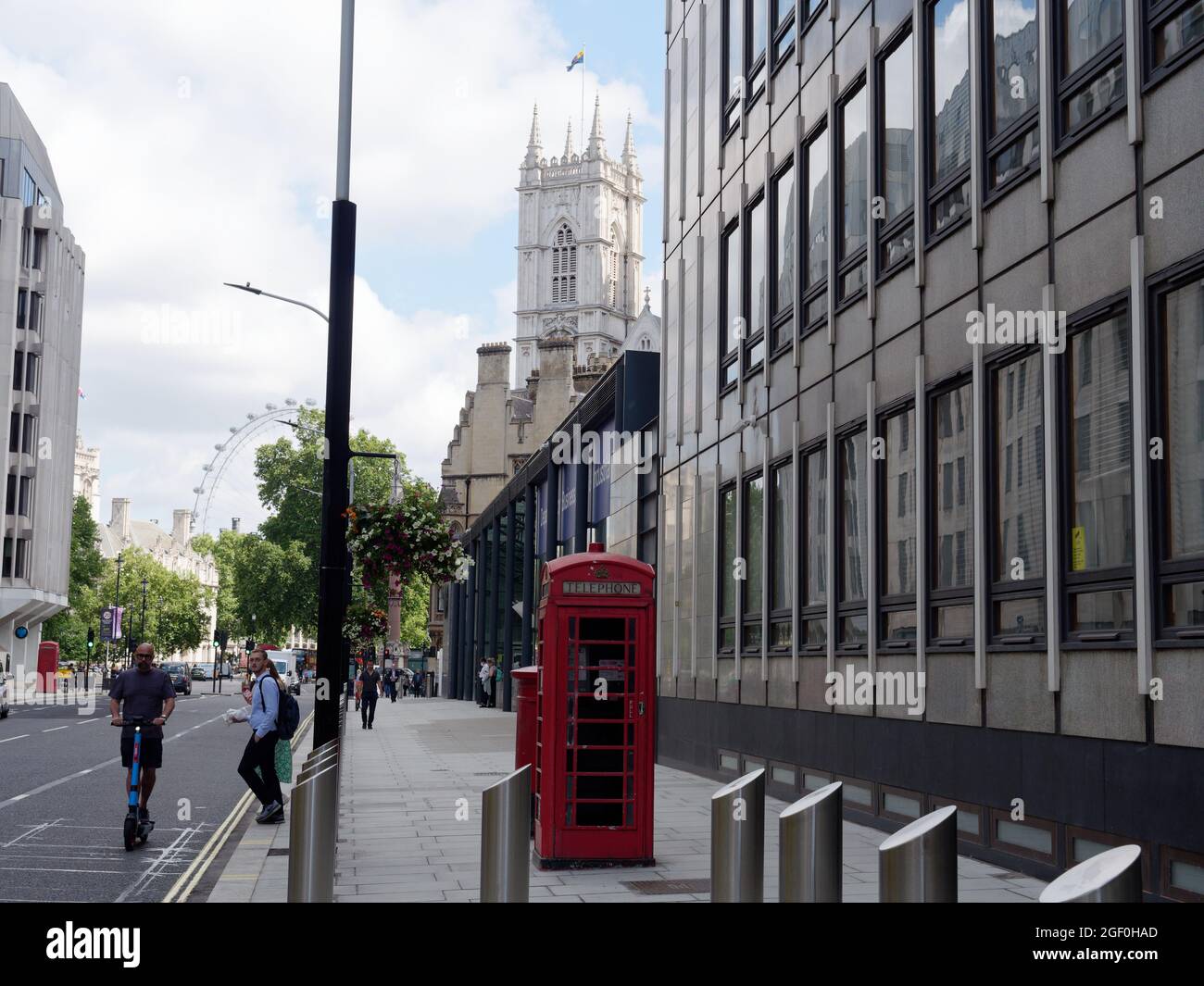 London, Greater London, England, August 10 2021: Victoria Street. The London Eye and a tower of Westminster Abbey behind. Stock Photo