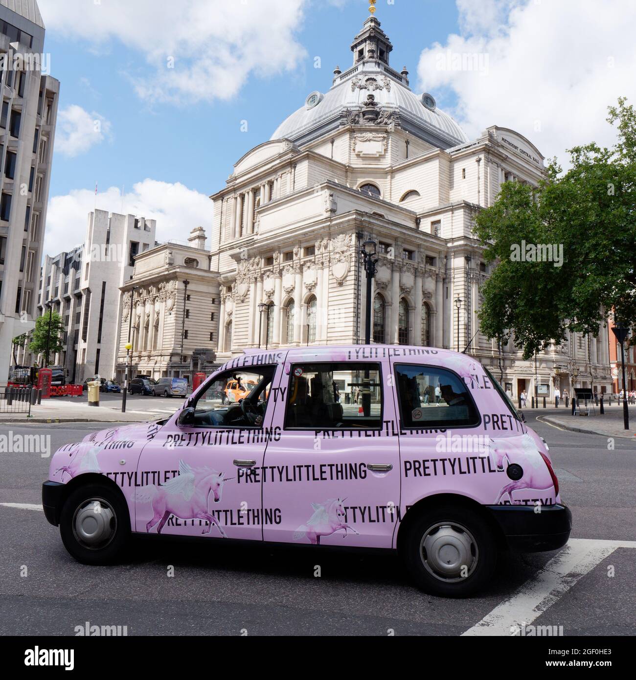 London, Greater London, England, August 10 2021: Pink Prettylittlething Taxi in front of Central Hall Westminster aka Methodist Central Hall. Stock Photo