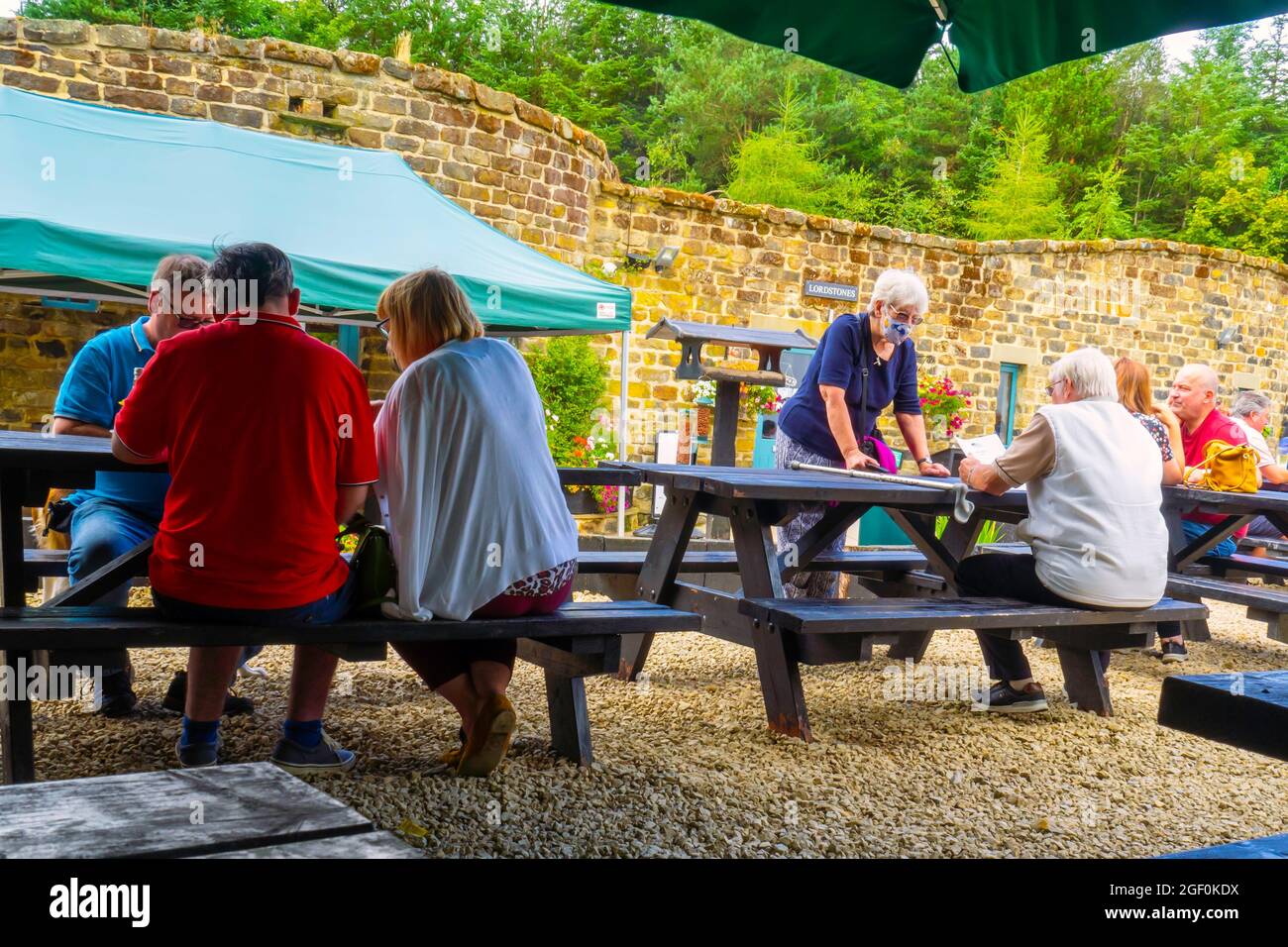 Customers at Lord Stones Café, prefering to eat outside under a large awning rather than going inside the café Stock Photo