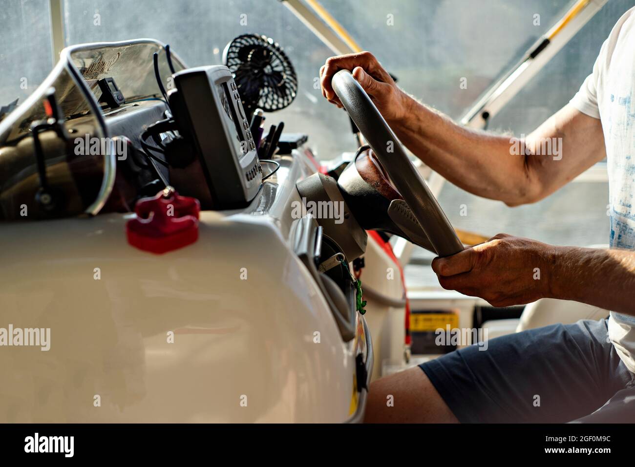 Hands driving motorboat hi-res stock photography and images - Alamy